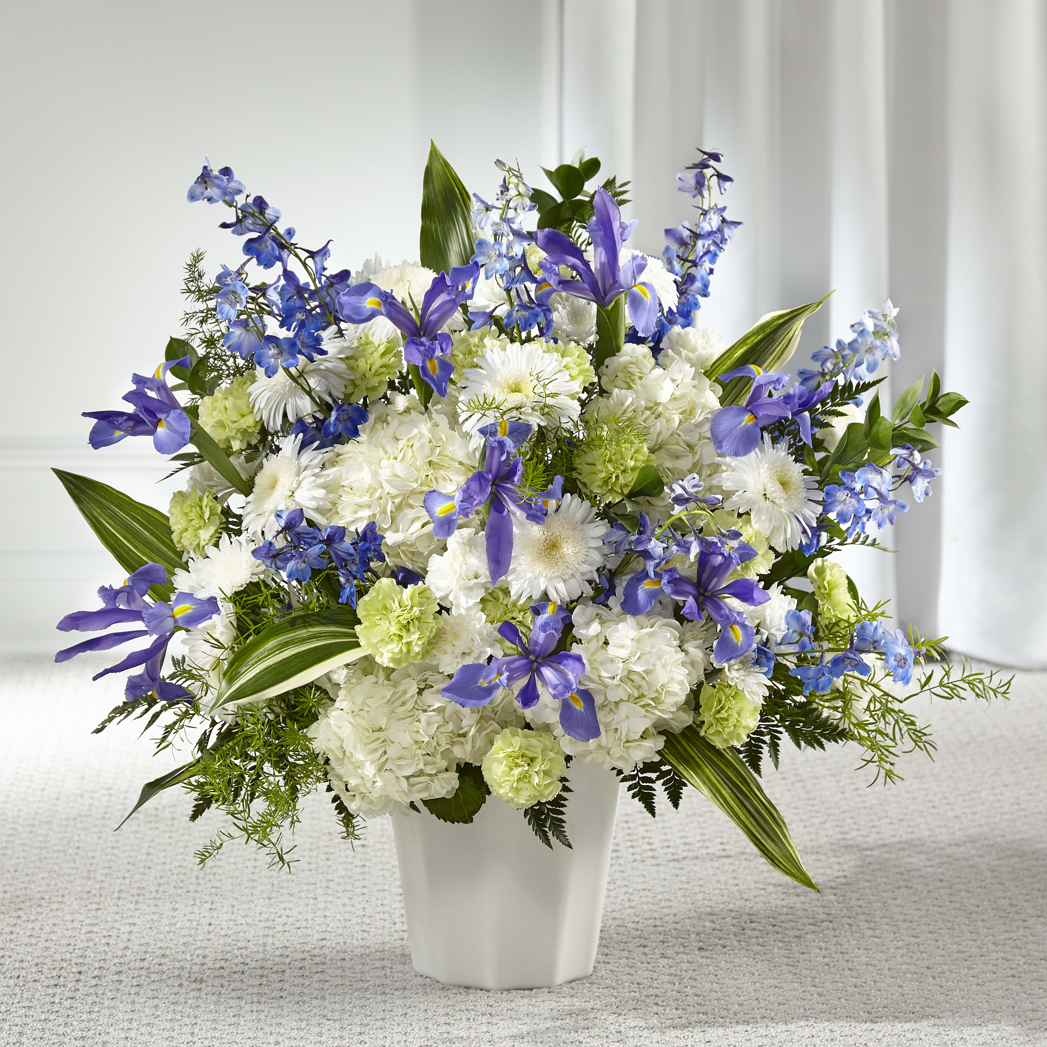 Serene Skies Floor Arrangement Serene Skies Floor Arrangement - Assortment of blue and white flowers. Standard option is pictured. May vary from photo
