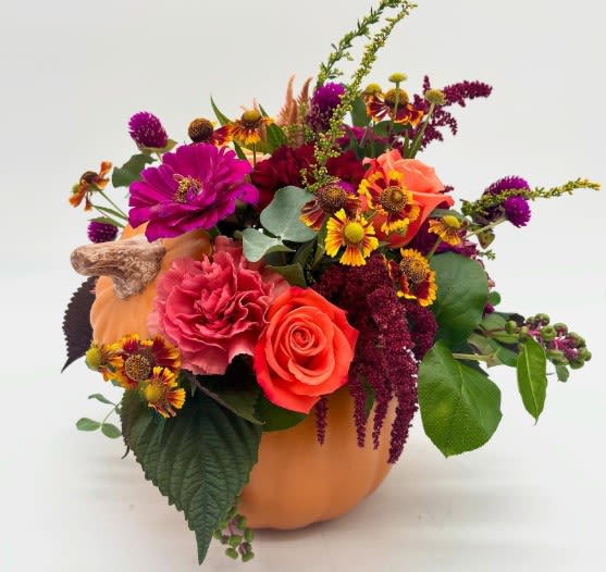 Hey There, Gourdgeous Hey There, Gourdgeous - Bright and seasonal flower mix created in an orange pumpkin container. Perfect for fall gatherings!