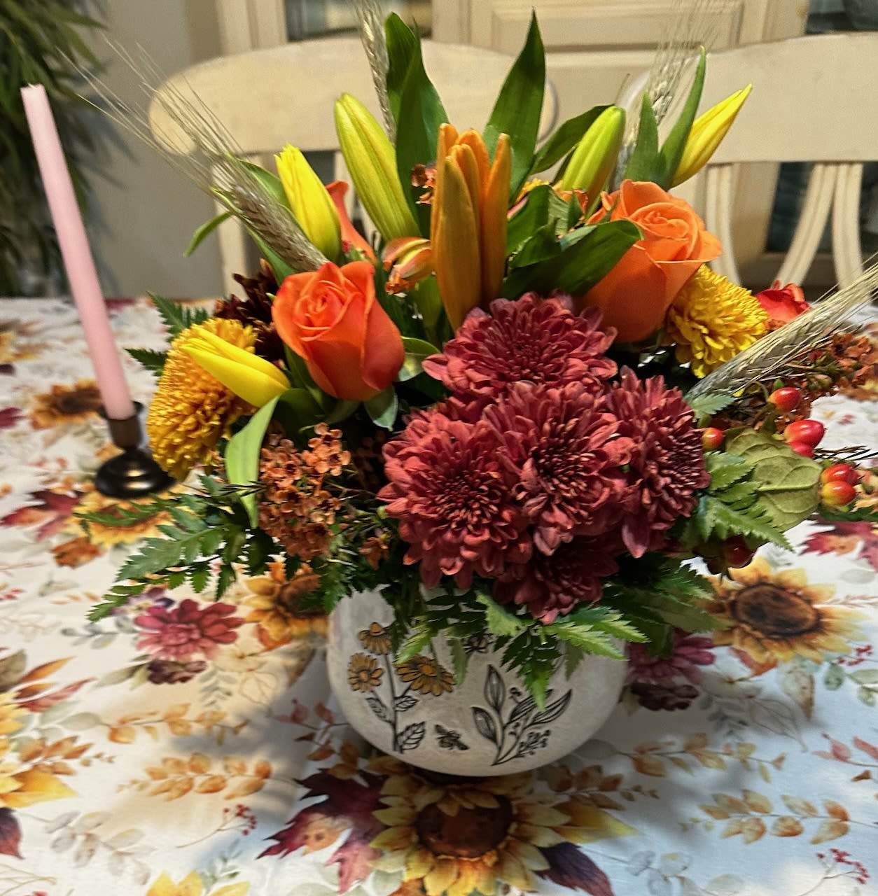  Autumn in New England - Orange roses, yellow asiatic lilies, bronze mums, burgandy chrysanthemums, red hypericum berries, orange wax flower, assorted greens and wheat arranged in a keepsake ceramic container