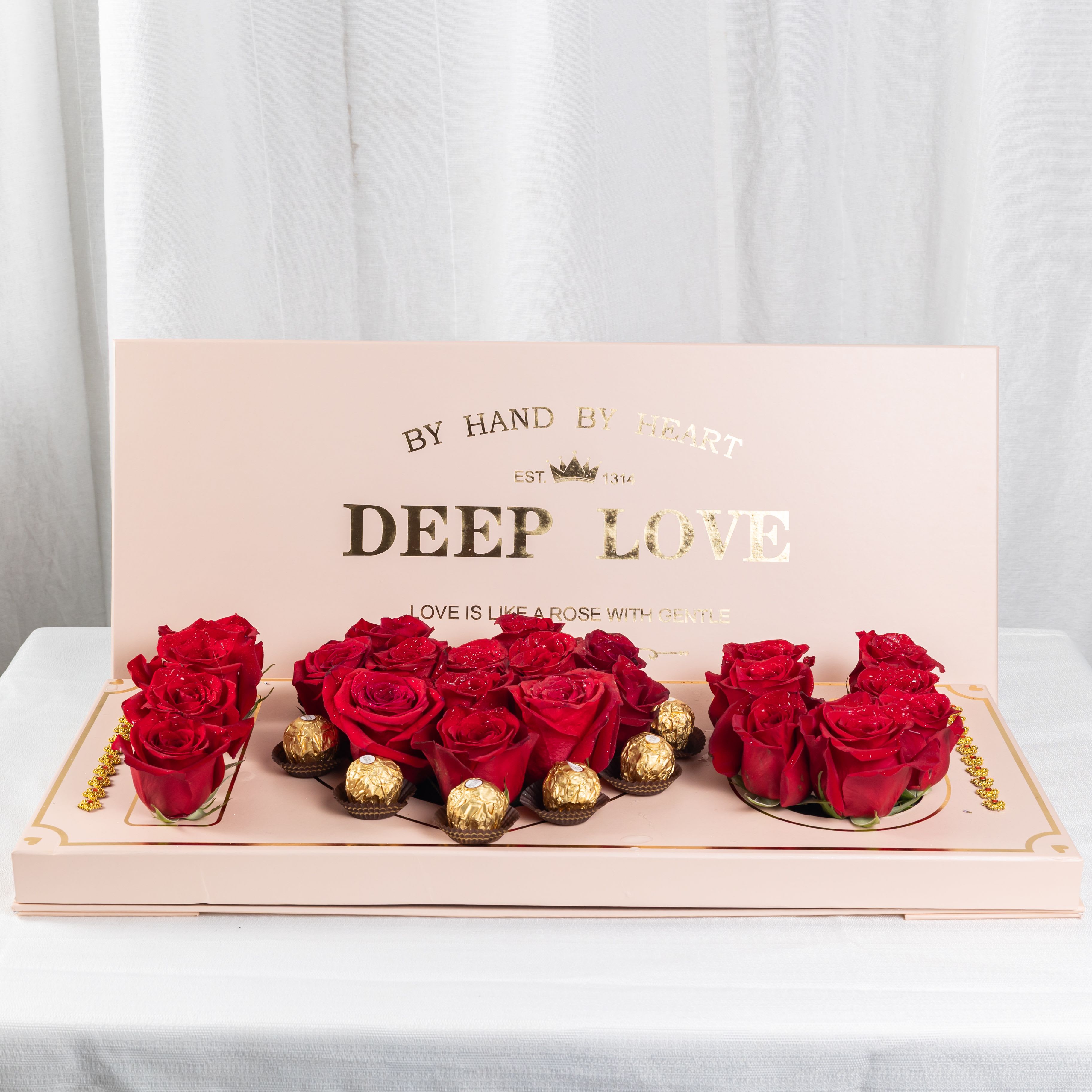 Golden Love - A heart-shaped blend of red roses and gold-wrapped chocolates, set against a soft pink base with a poetic golden message. A refined gift that speaks of deep love and timeless elegance.