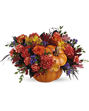 Teleflora Hauntingly Pretty Pumpkin - Bursting from a gorgeous glazed ceramic pumpkin bowl, this fabulous fall mix of alstroemeria and carnations is a hauntingly beautiful addition to your autumnal gatherings! This bouquet features orange alstroemeria, dark orange carnations, miniature orange carnation, purple sinuata statice, parvifolia eucalyptus, red agonis, and lemon leaf. Delivered in a Trick &amp; Treat Pumpkin.