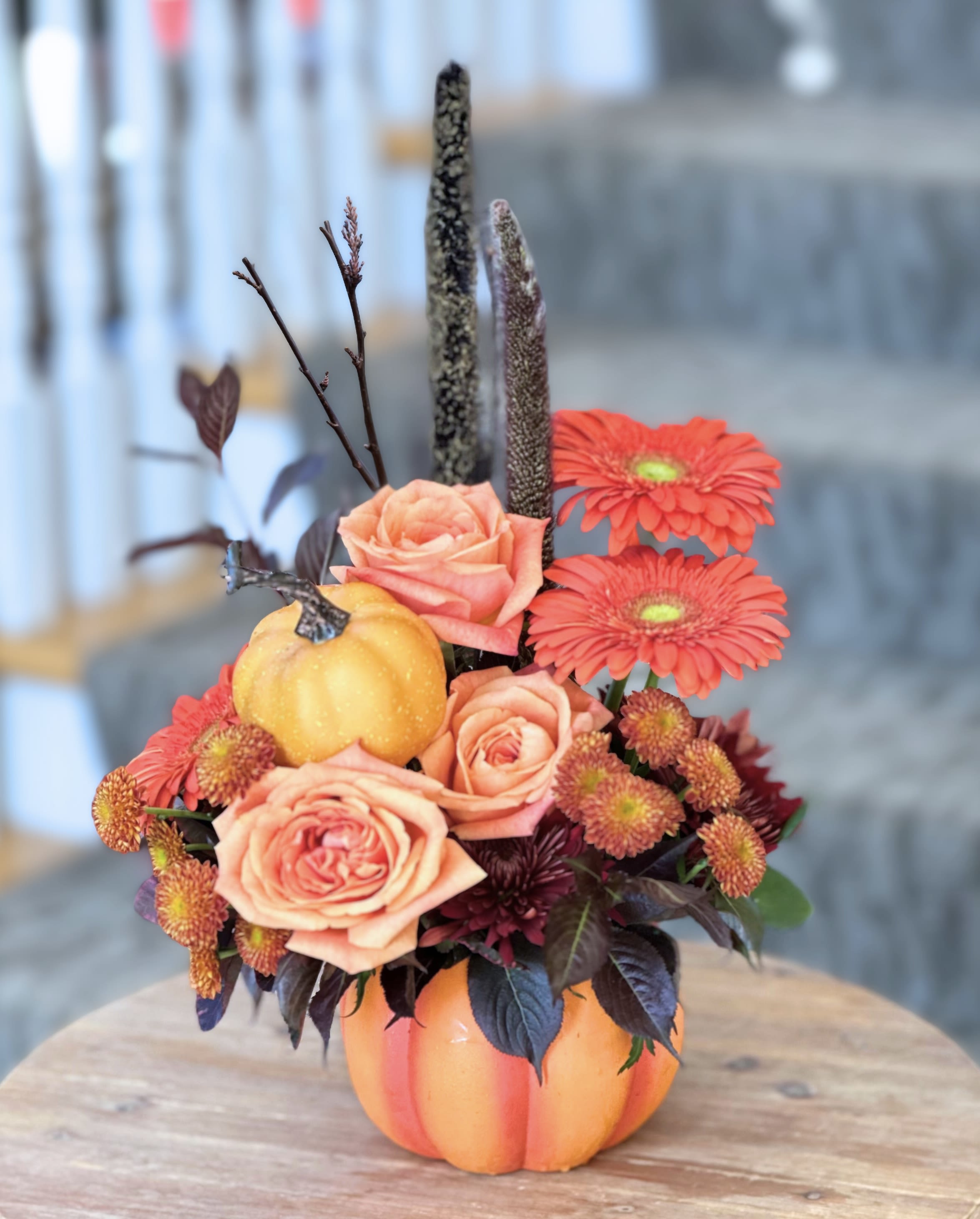 Pumpkin Patch Pumpkin Patch - FALL COLLECTION | LOCAL DELIVERY ONLY Celebrate the season with this playful ceramic pumpkin arrangement, filled with a bright fall mix of roses, gerbera daisies, mums and other fall accents like branches, cat tails with touches of burgundy foliage. Perfect for adding a pop of autumn color and charm to any space.