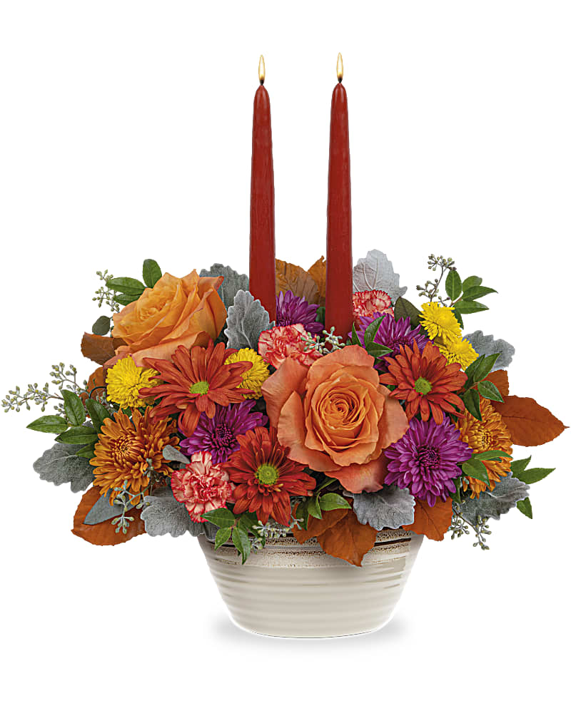 Rustic Chic Centerpiece - A chic choice for your fall table, this elegant autumnal rose arrangement is presented in a stunning stoneware serving bowl centerpiece with eye-catching reactive glaze detail. This autumn floral arrangement includes orange roses, miniature orange carnations, lavender button spray chrysanthemums, bronze cushion spray chrysanthemums, dark bronze daisy spray chrysanthemums, brown copper beech, dusty miller, seeded eucalyptus, huckleberry and two dark burgundy candles. This Rustic Chic Centerpiece is delivered in Teleflora's Rustic Harvest Bowl.