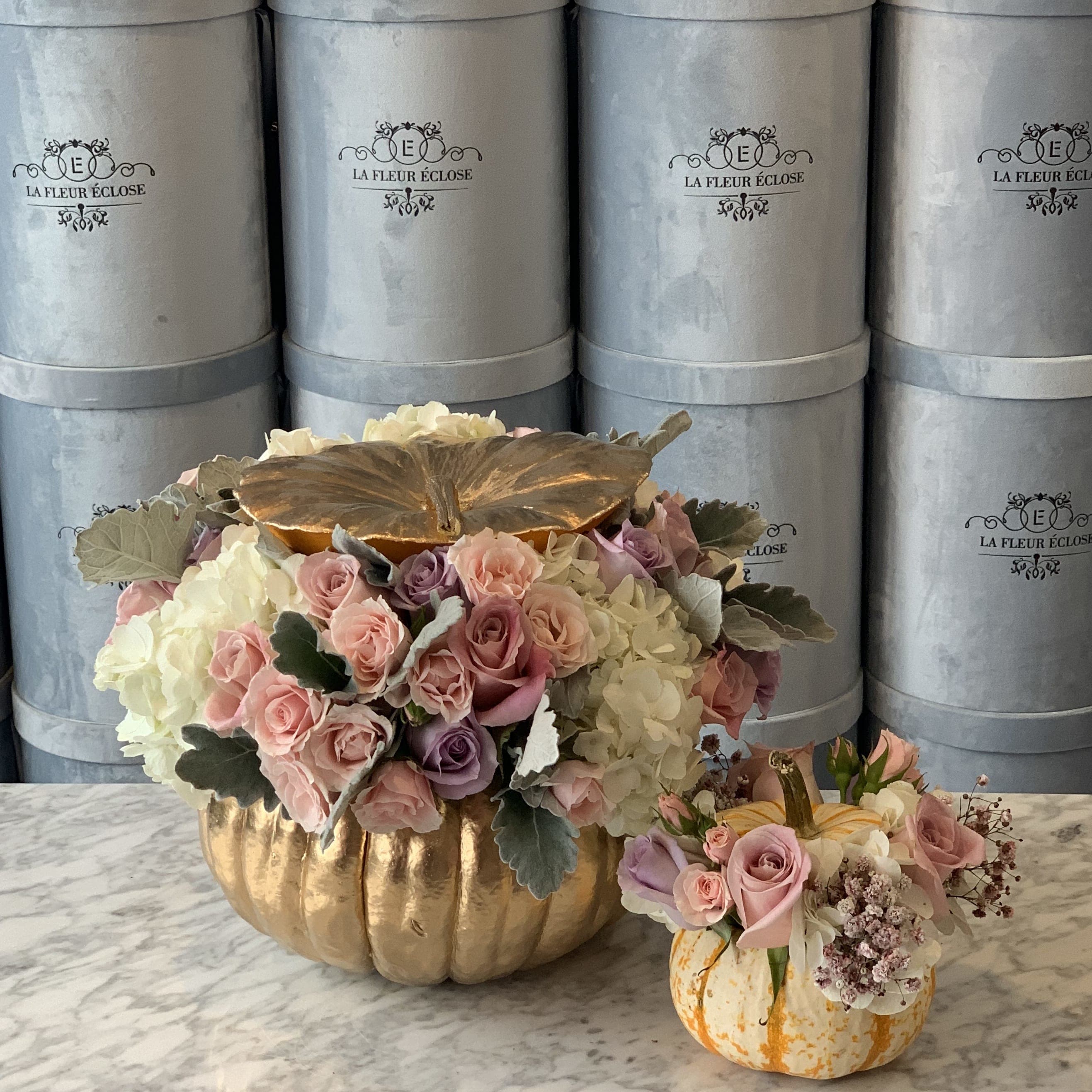 Pumpy  Pumpy  - A real pumpkin painted with gold with roses, hydrangeas baby roses and dusty miller leaves.