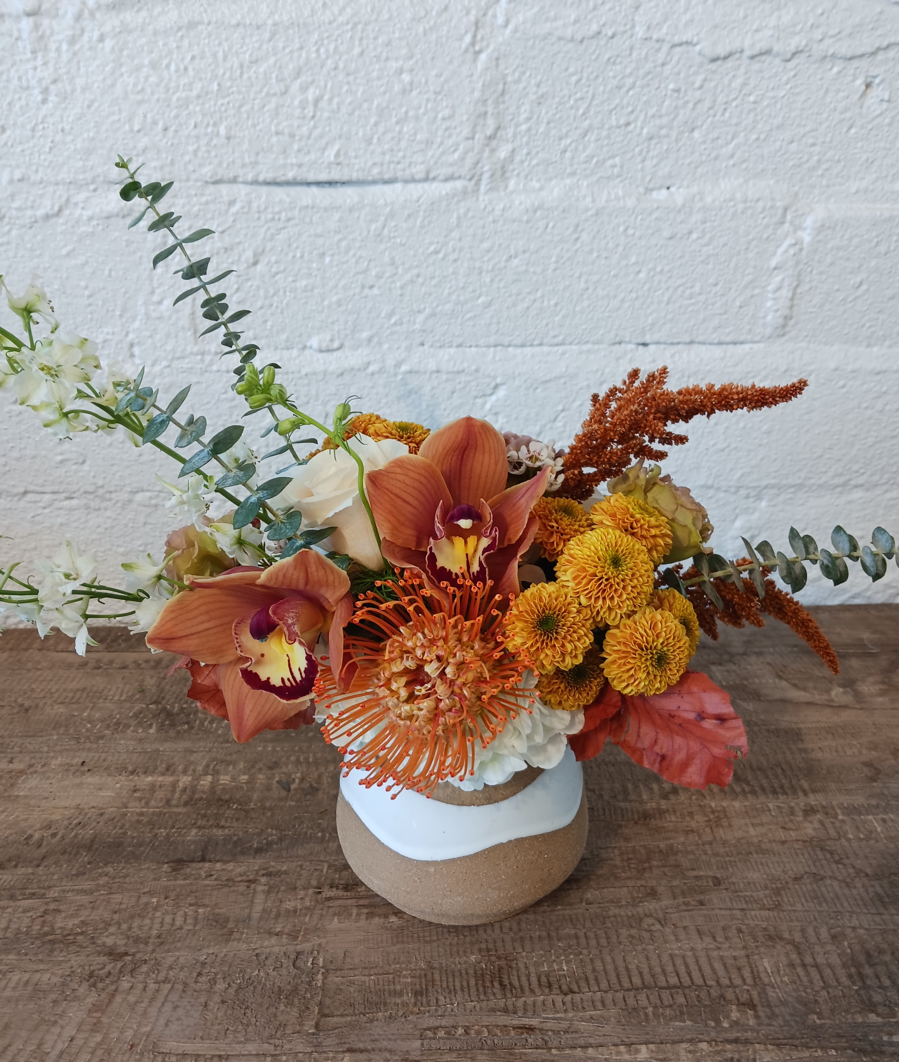 Golden Hour - Soft and elegant, our &quot;Golden Hour&quot; arrangement brings a timeless beauty to any space. This compact style arrangement features delicate antique-colored blooms with hints of yellow and white, thoughtfully arranged in a textured ceramic vase. Perfect for adding a touch of subtle sophistication to your home, this arrangement captures the essence of vintage elegance with a modern twist.
