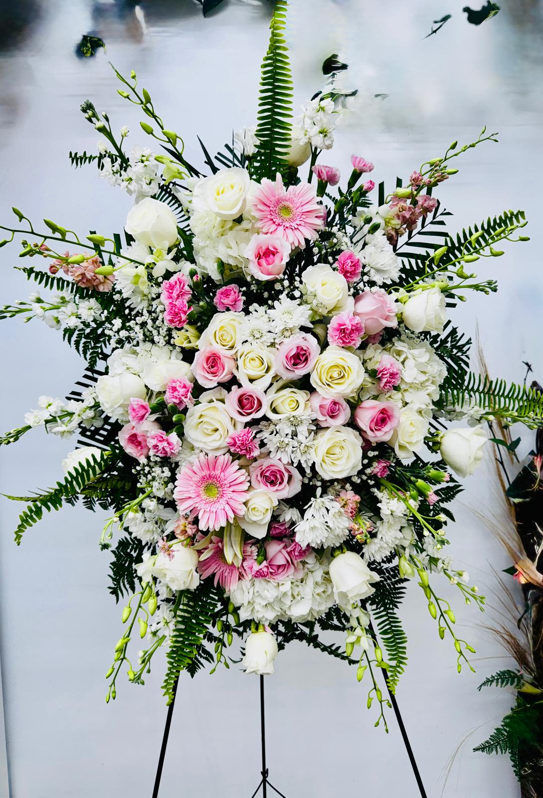 Offering Solace Standing Spray Offering Solace Standing Spray - Artfully arranged pink and white florals create a captivating standing spray to honor a beautiful life.