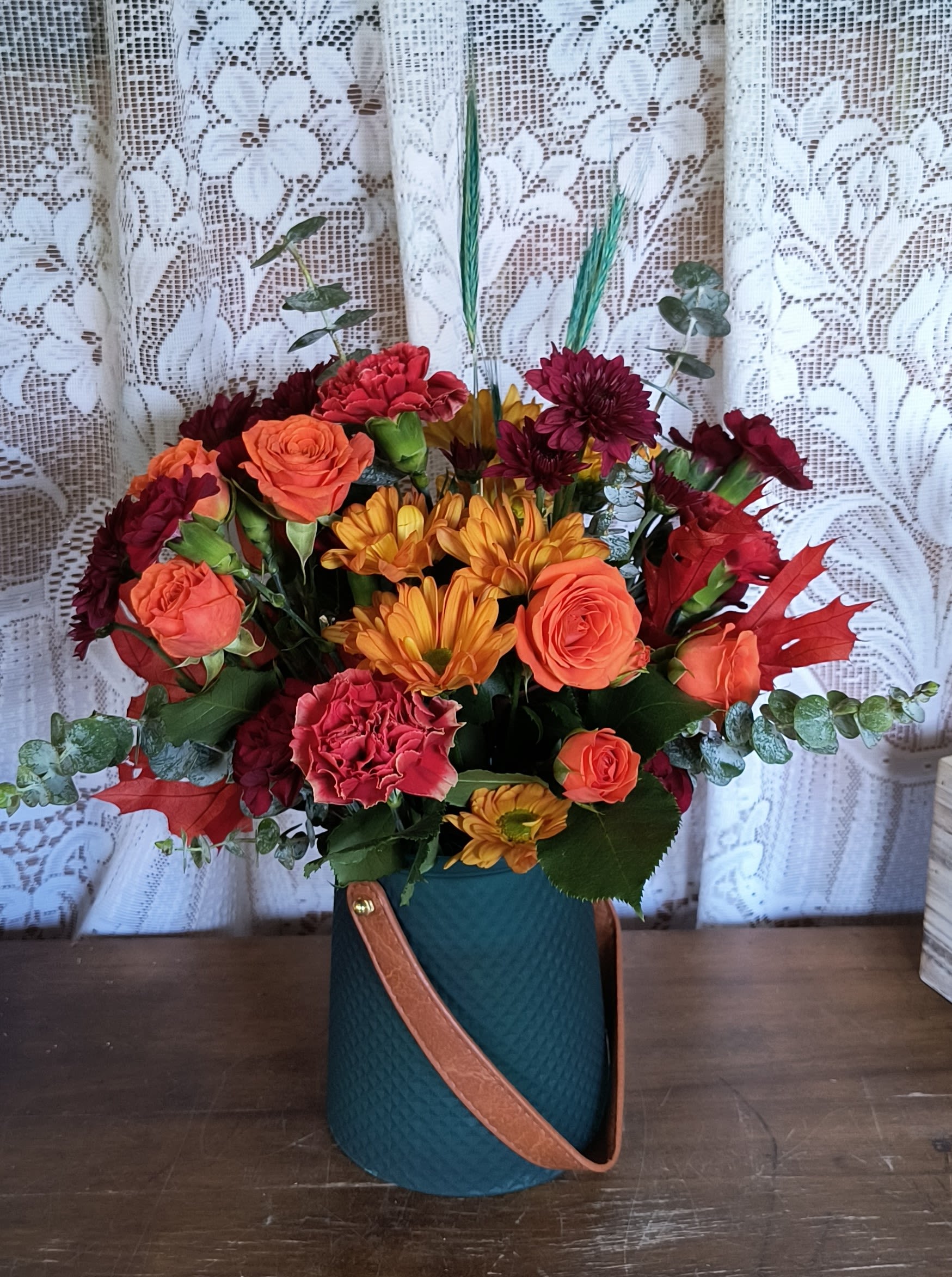 Deluxe Riches - Beautiful and Bold the rich colors of this fall bouquet. Artfully arranged in a teal vase.