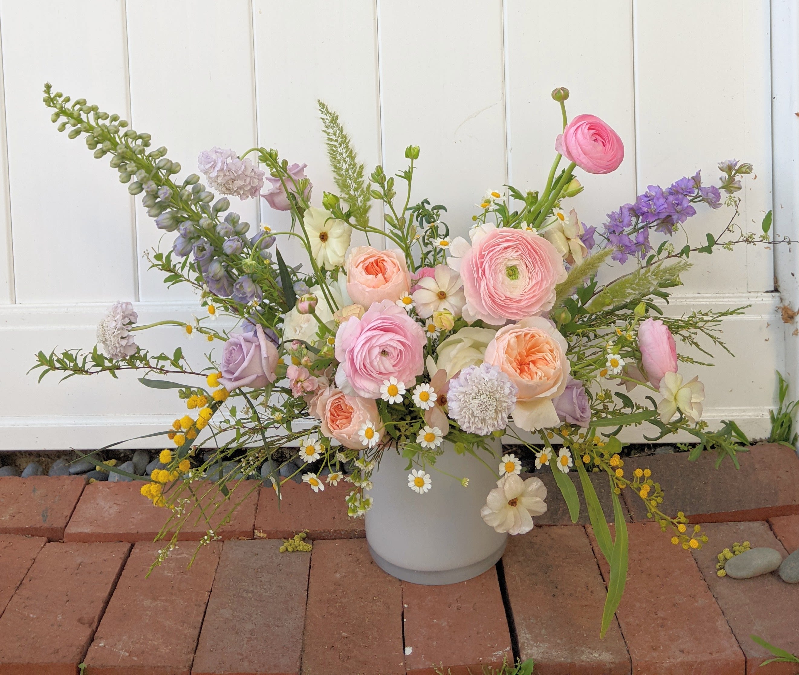 From Her Garden  - A natural-esque soft palette arrangement in a white glass vase as if it were picked from a field of wildflowers. 