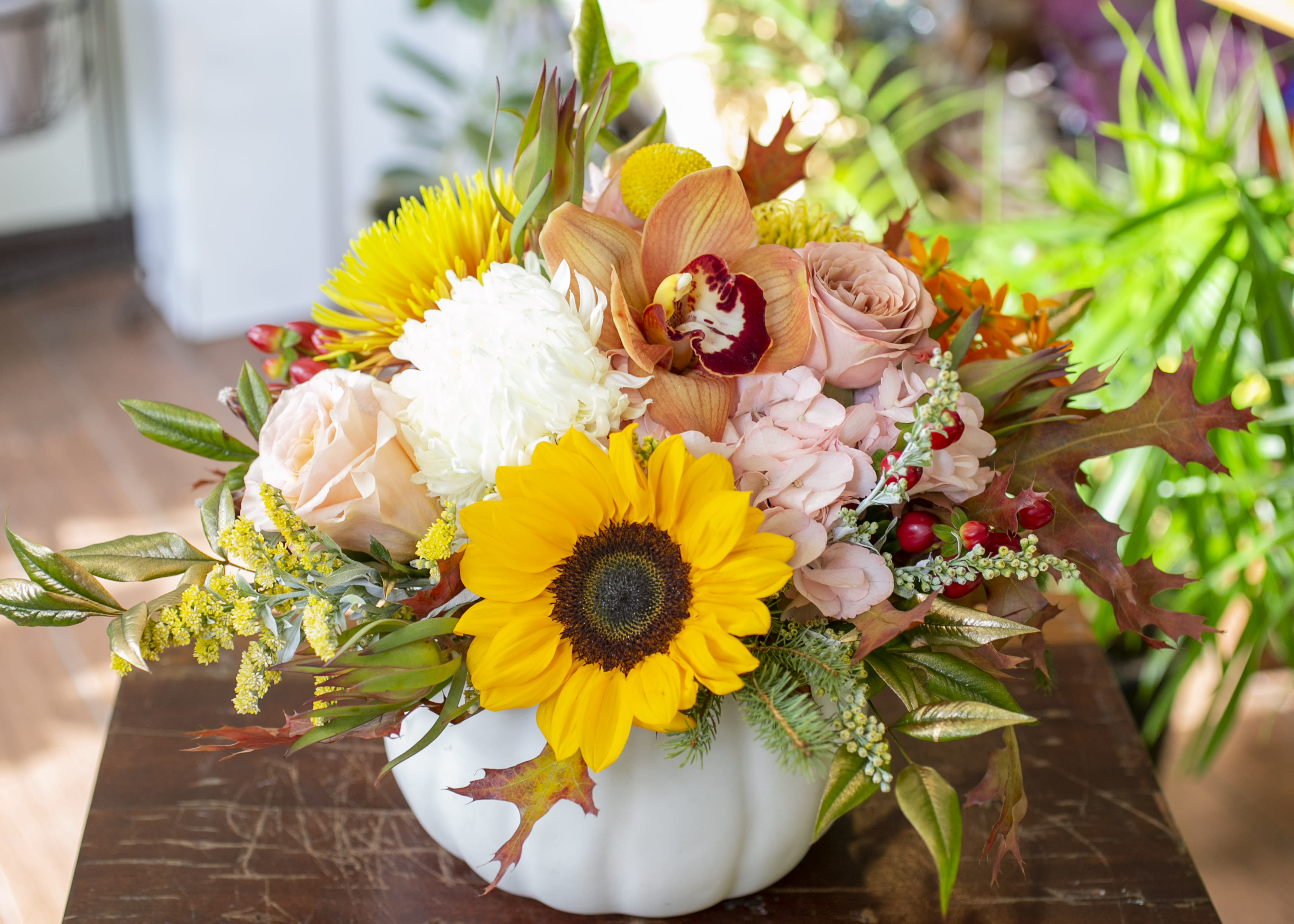 Reagan - White ceramic pumpkin filled with seasonal blooms and accents