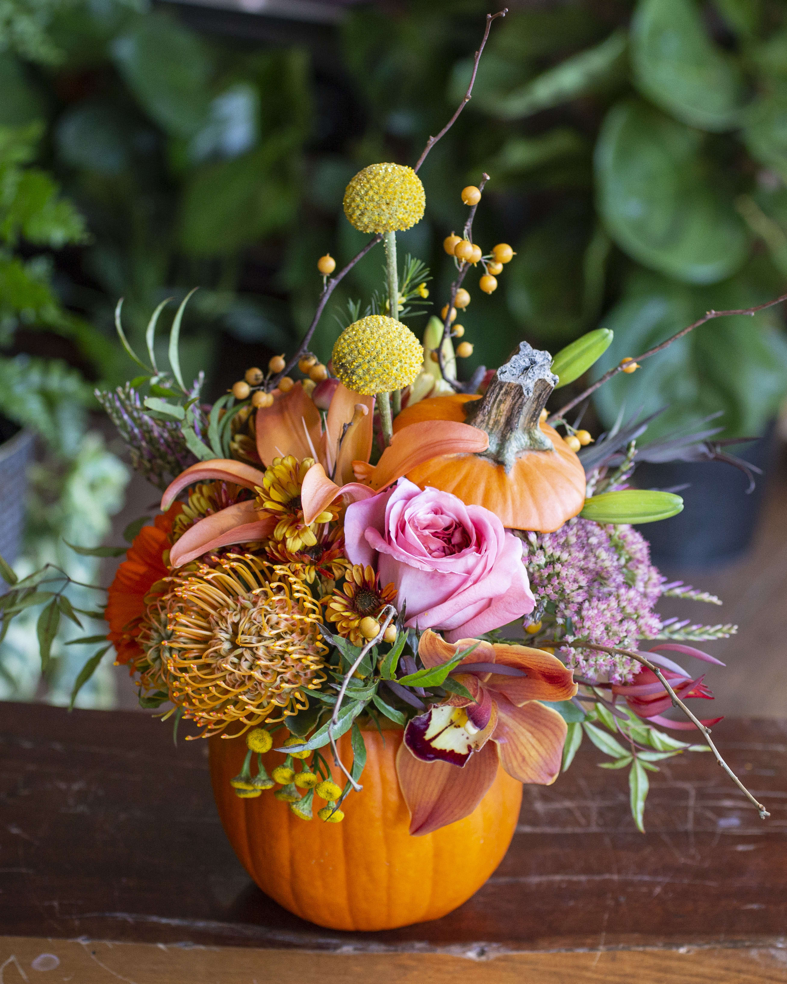 Sally - Next level pumpkin carving... real pumpkin full of beautiful blooms. If you have flower color preferences, please note them in special instructions!  