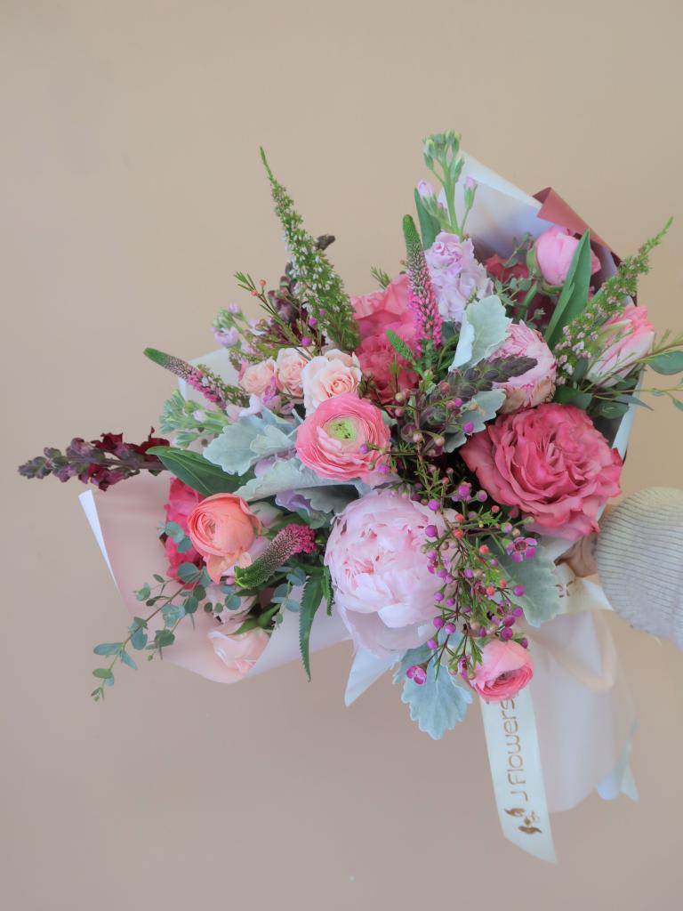 Making Me Blush Bouquet  - An assortment of pink hued flowers wrapped in premium paper.  (Bouquet comes with stems wrapped in a compostable sponge with water) 