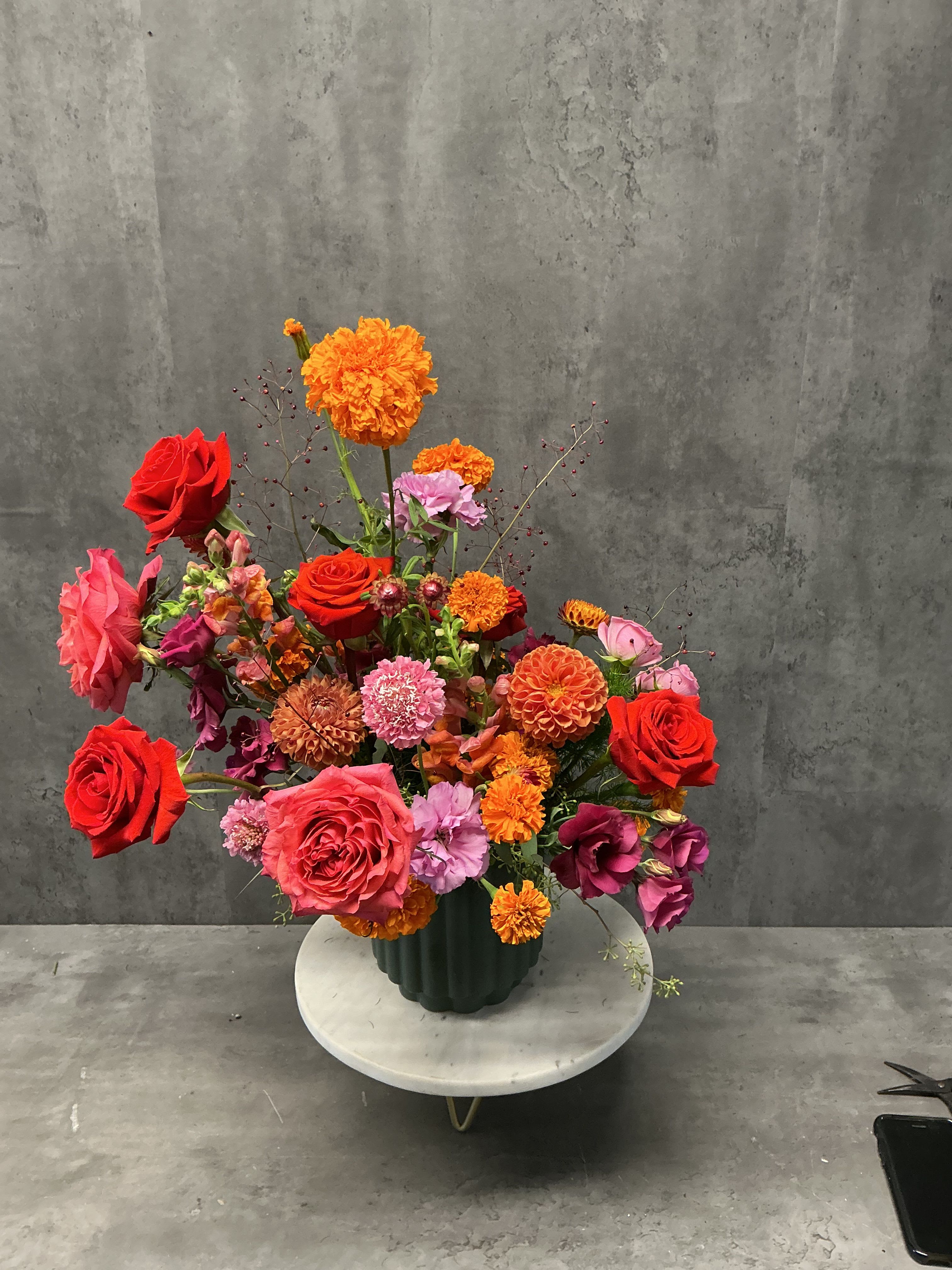 Crimson Sunset Crimson Sunset - Moody and romantic, created in a dark green ceramic vase. ***flowers will vary based of availability, overall feel and color will remain the same***