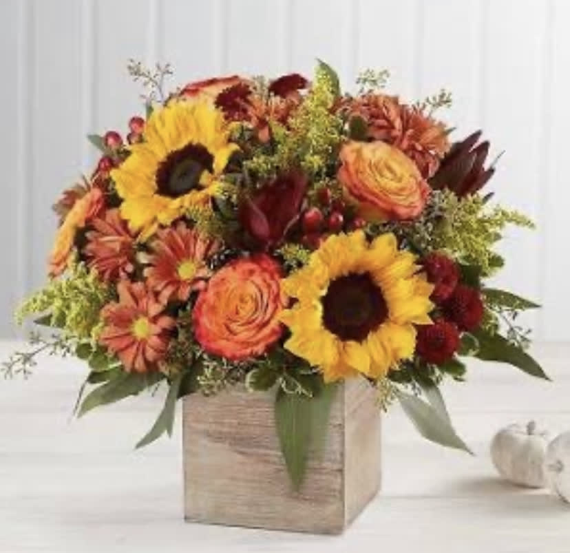 Rustic Fall - This arrangement had a variety of Fall flowers arranged inside of a box. It delivers warmth and happiness in the form of fall flowers. Do this arrangement a favor and let it deliver happiness to someone. Order one today! 