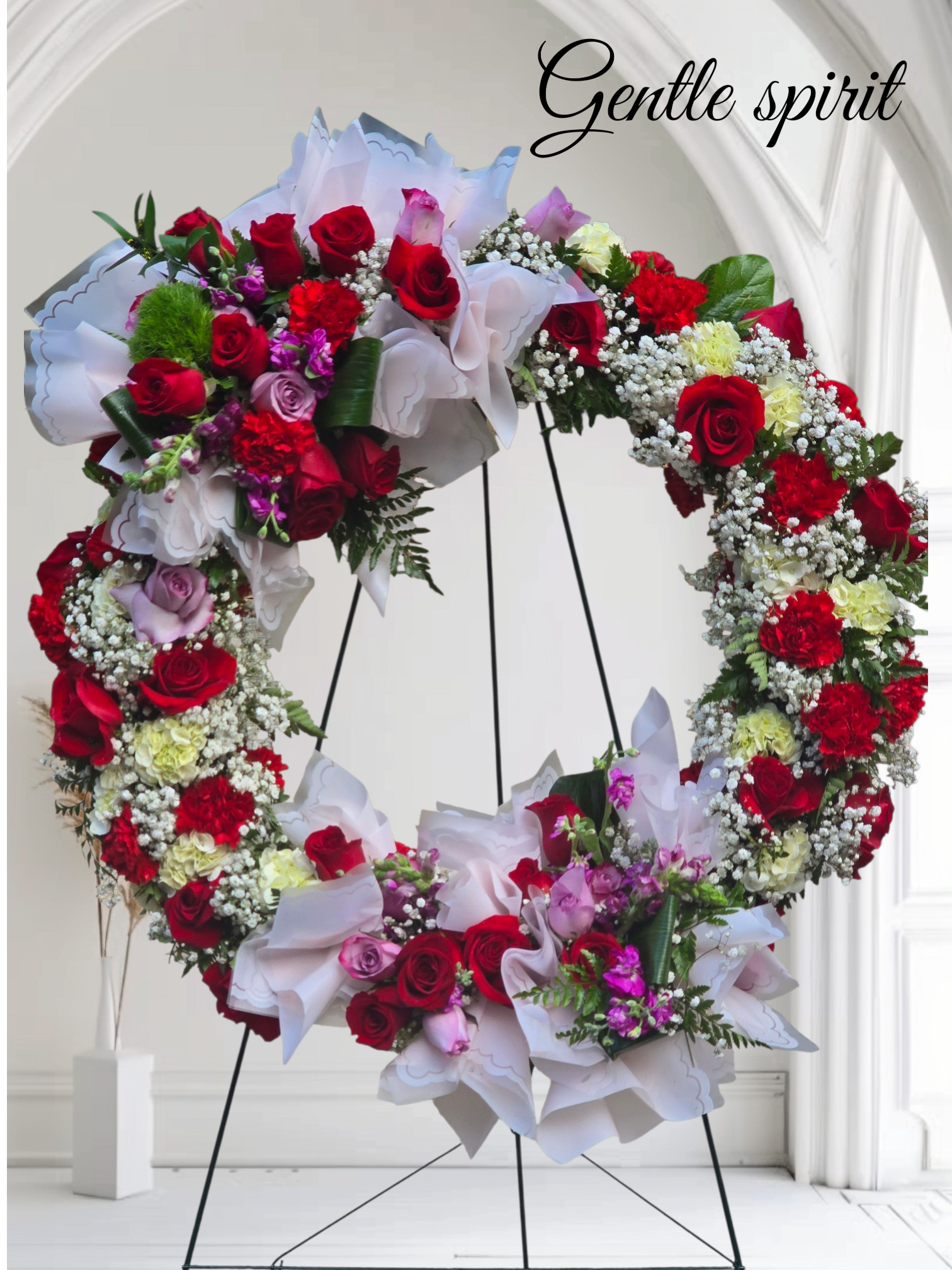 Gentle Spirit  - Beating Memorial wreath adorned with baby's breath Red and pink roses, red Carnations and white hydrangeas 