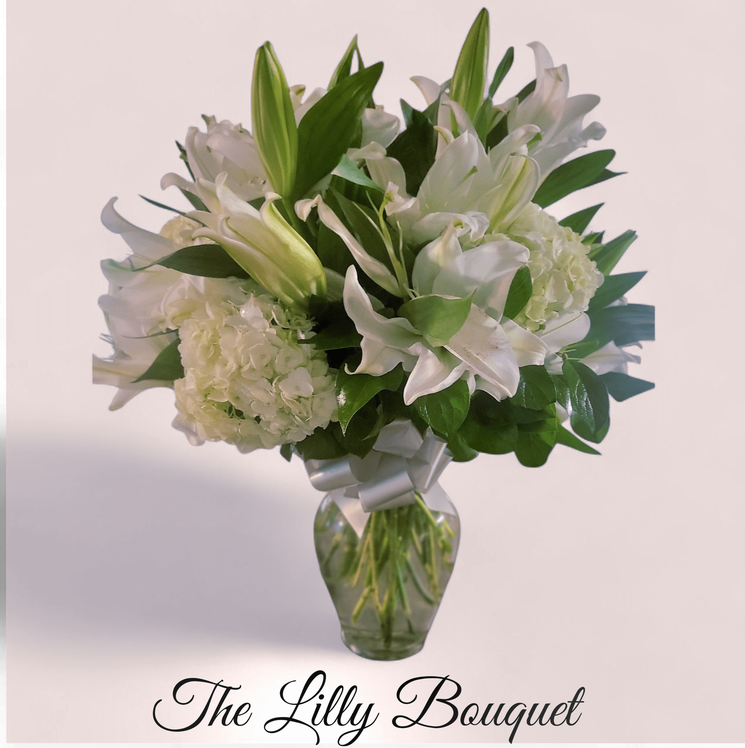 Lilly Bouquet Lilly Bouquet - An elegant arrangement of white hydraengeas and white Lillies designed in a glass vase.