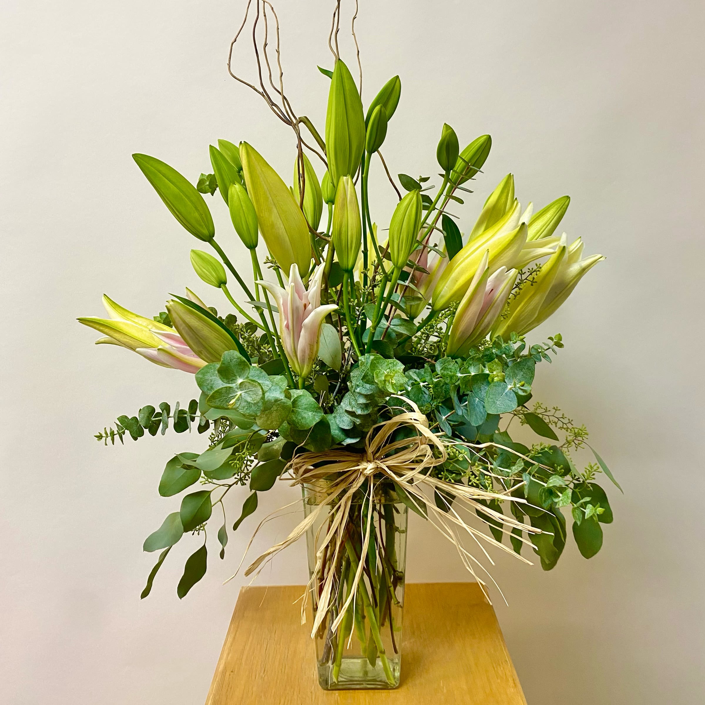 Modern Lily Modern Lily - This Modern Lily Arrangement Includes Lilies with Premium Greenery in a Glass Vase. Or as Similar as Possible. Write Color Preference in Special Instructions at Checkout. Color Options: White Light Pink