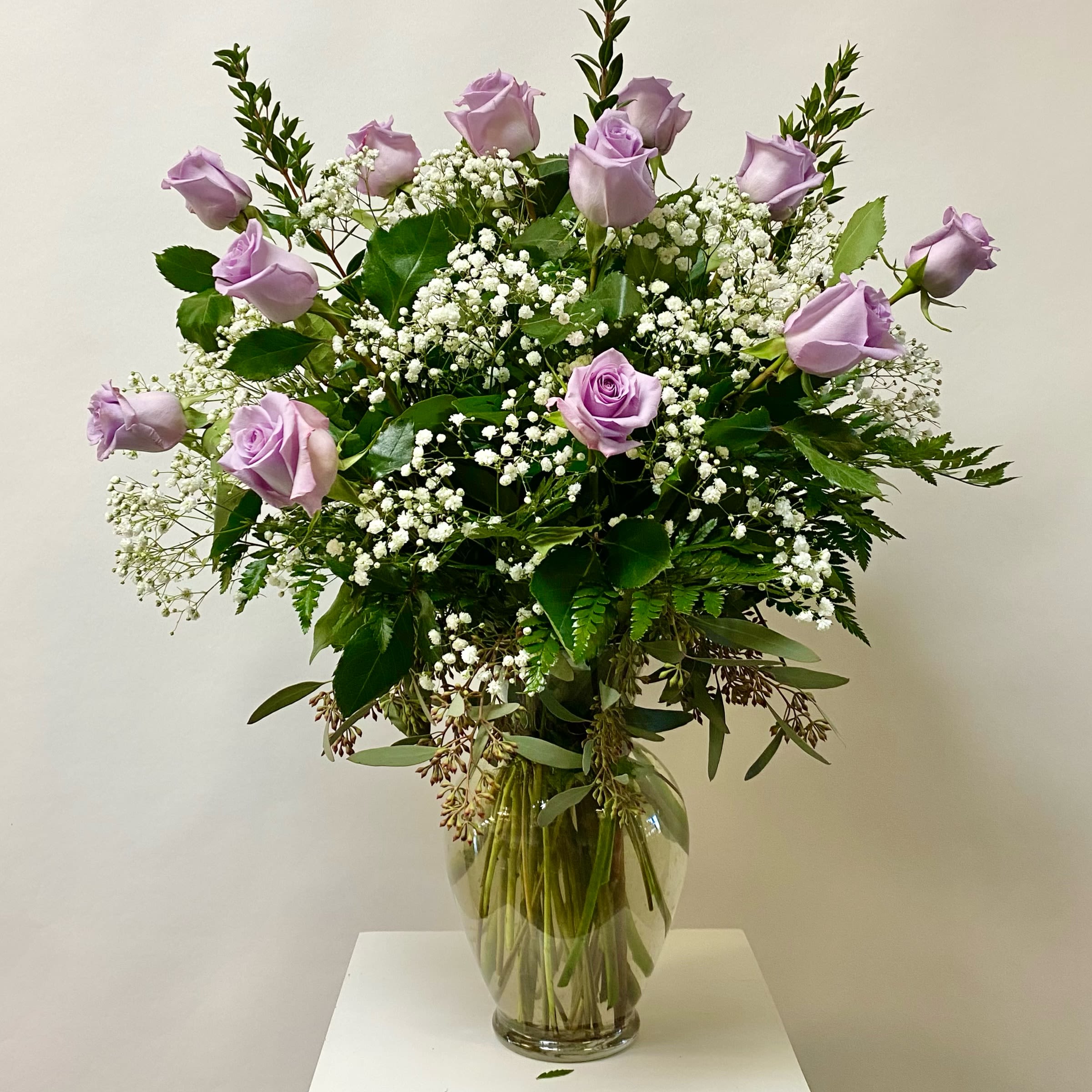 Classic Lavender Dozen Classic Lavender Dozen - Lavender Dozen Roses with W/ Filler in a Glass Vase. Filler Flowers will be either Babies Breath or Wax flowers. Write in the Special Instructions if you have a preference Babies Breath or Wax Flower.