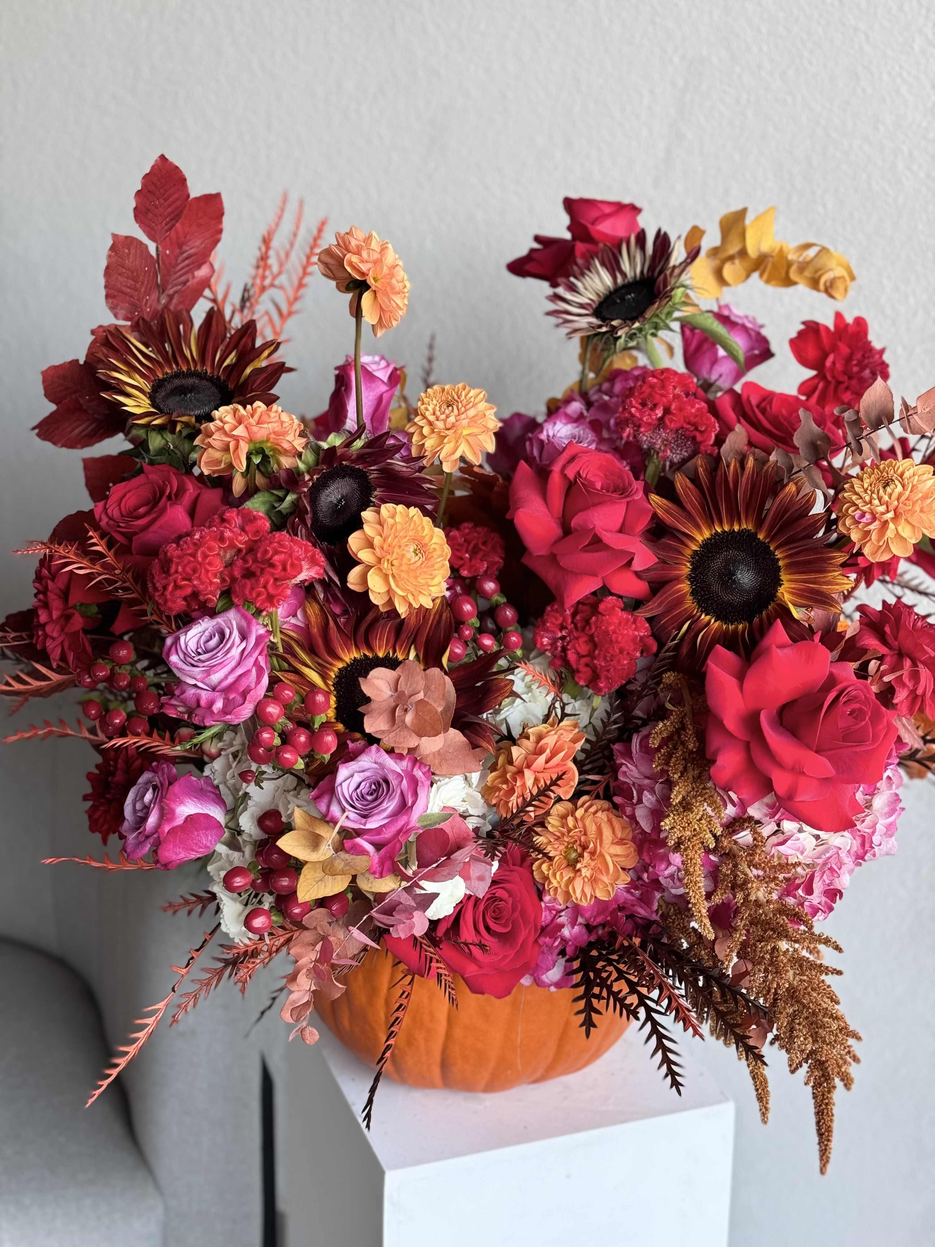Fall is here Fall is here - Fall arrangement is here. Capture the beauty of fall with the warm autumn hues of this lush rose bouquet, artfully arranged in a copper-finished keepsake bowl with timeless hammered detailing. Perfect for any occasion. Arrangement includes: flowers Pumpkin Custom greeting card