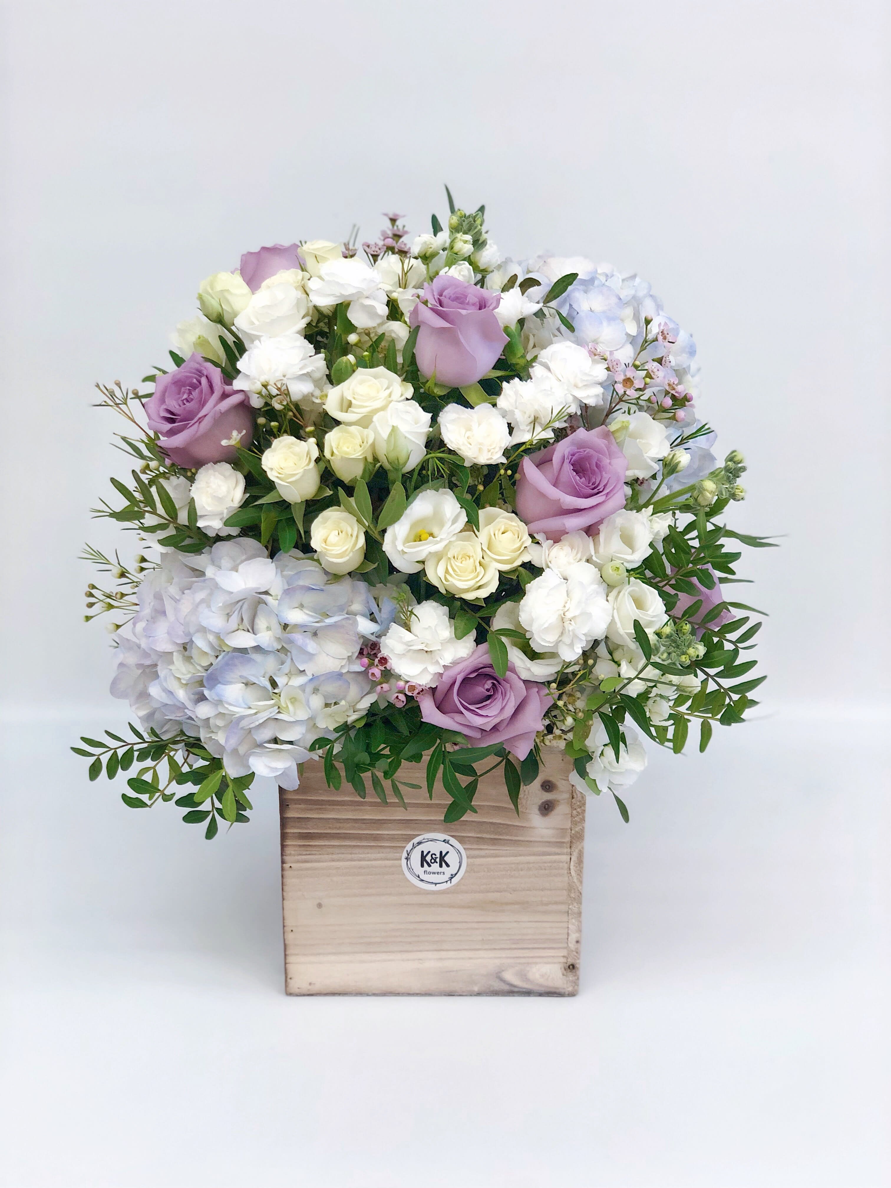Tall Wood Box Arrangement Lavender & White Tall Wood Box Arrangement Lavender & White - If You want bouquet with a twist, choose our flower boxes. We have wood boxes for rustic-looking arrangements. It’s a beautiful and convenient way. Flowers in boxes don’t need vases. That makes it perfect for transportation and keeping flowers hydrated and secure.
