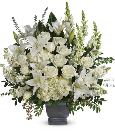 True Horizon True Horizon - An elegant sympathy arrangement made with fresh white blooms and arranged into a low grey container with mixed greenery.