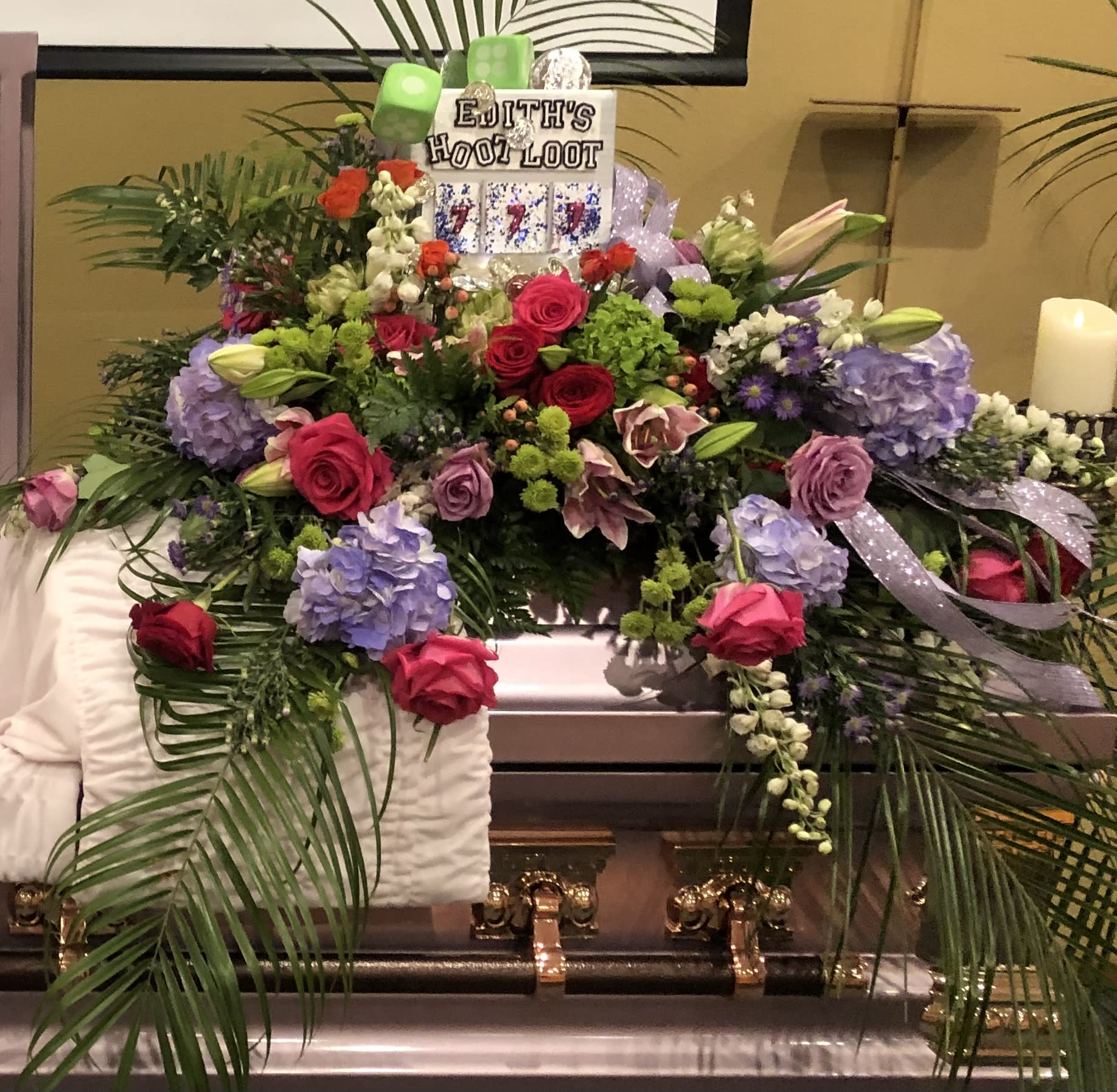 Casino Funeral Spray - A beautiful casket spray adorned with a slot machine. A loved send off.