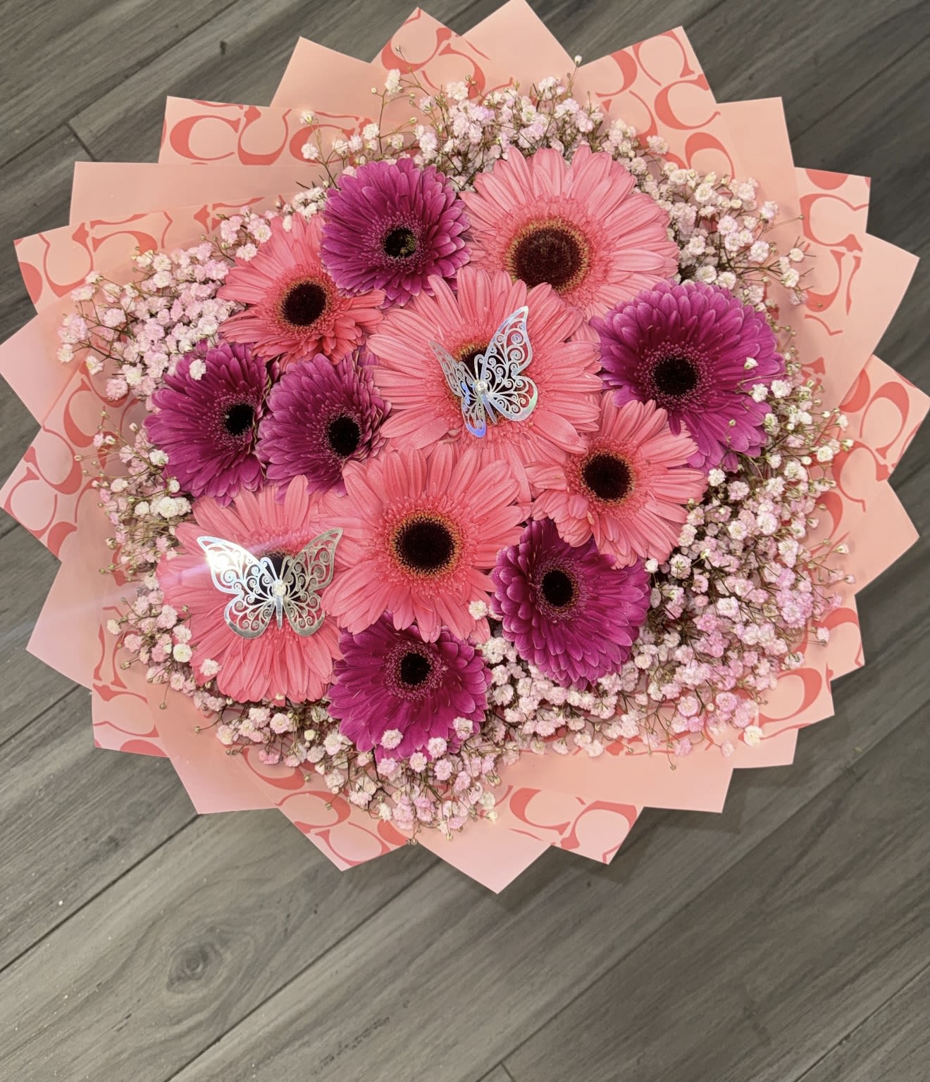 Gerber daisy cloud - 10 Gerber daisy pink themed bouquet with a baby breath  rim 