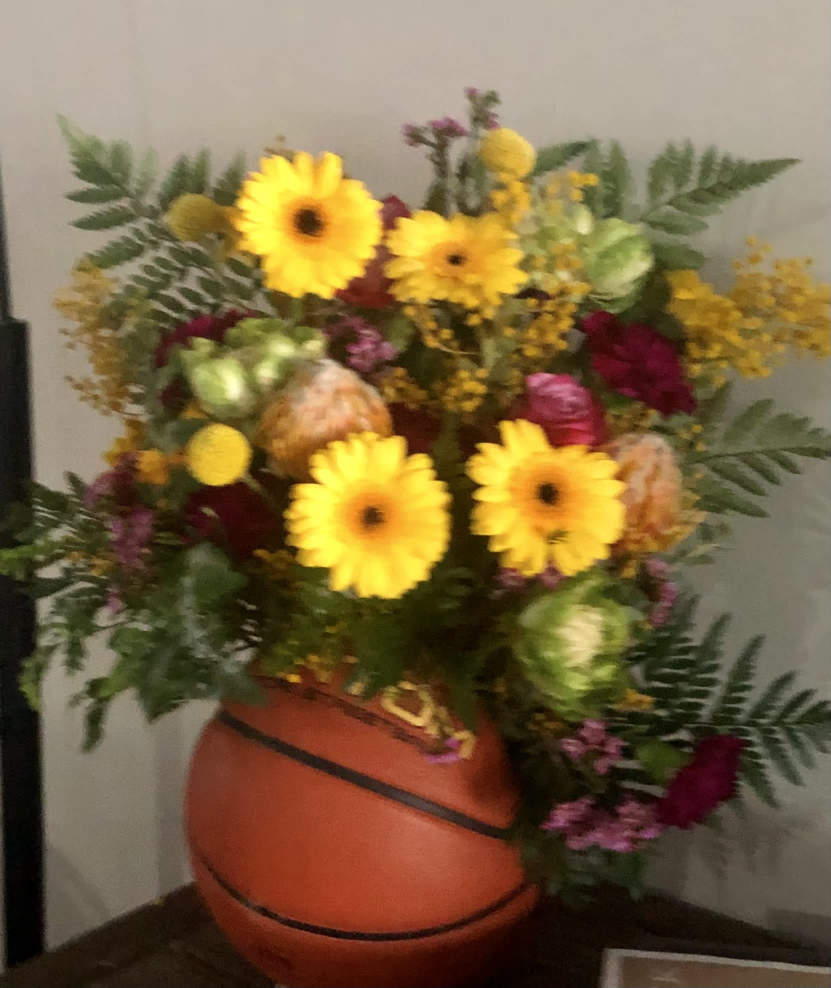 Basketball Floral - Seasonal blooms created in a real basketball
