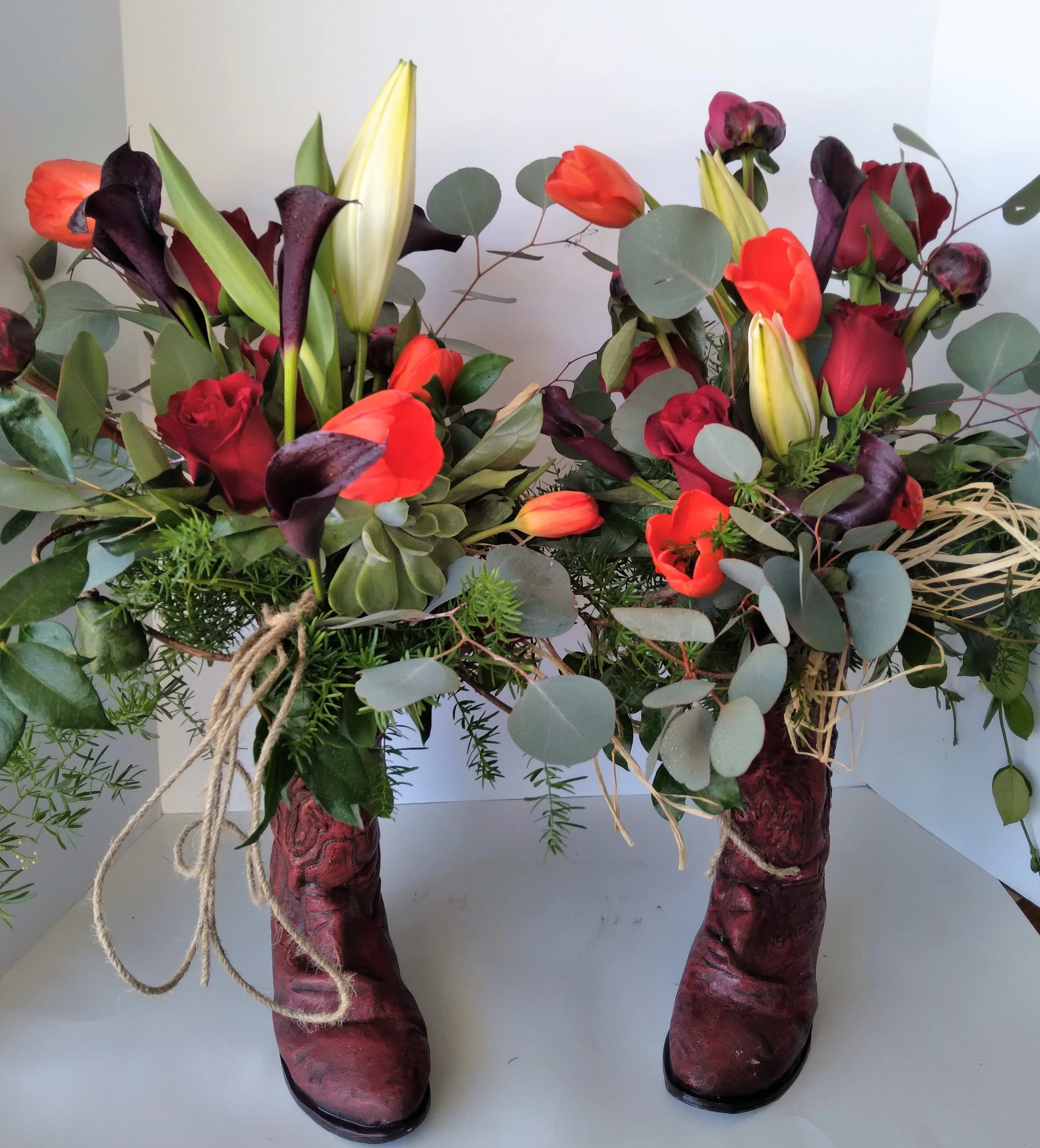 Boot Scootin Blooms - Assorted seasonal blooms and greens arranged in an old pair of cowboy boots. A pair unlike any other.