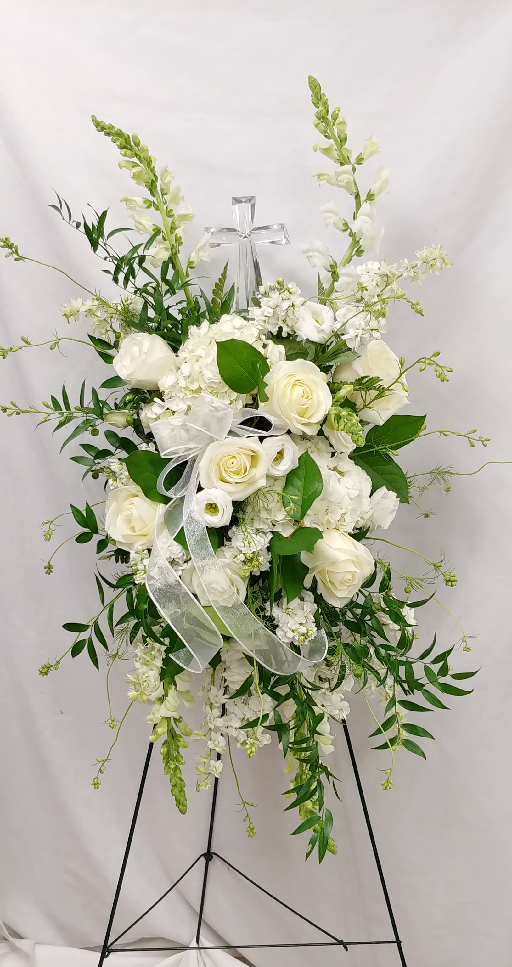 Tribute Spray - With a bounty white flowers and simple greens, this pretty spray lets you express your sympathy beautifully. 