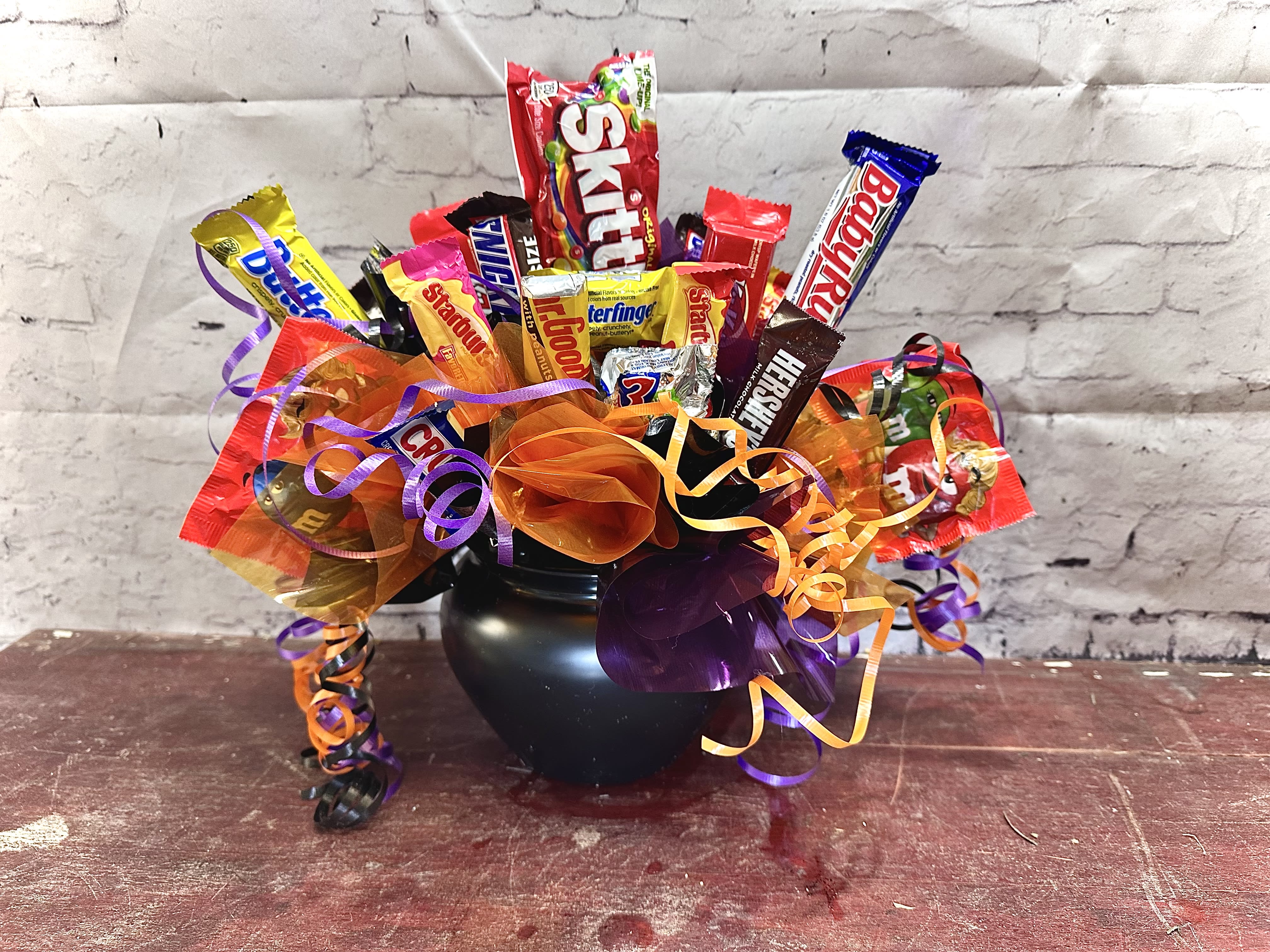 Candy cauldron  - Black plastic filled with Halloween candies for the spooky person in your life 