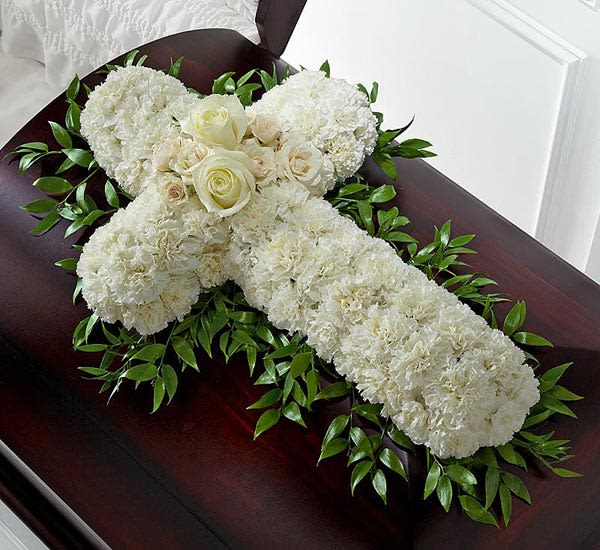 Casket Cross - This all white cross is designed with white carnations, white roses and Israeli ruscus- other colors available. 