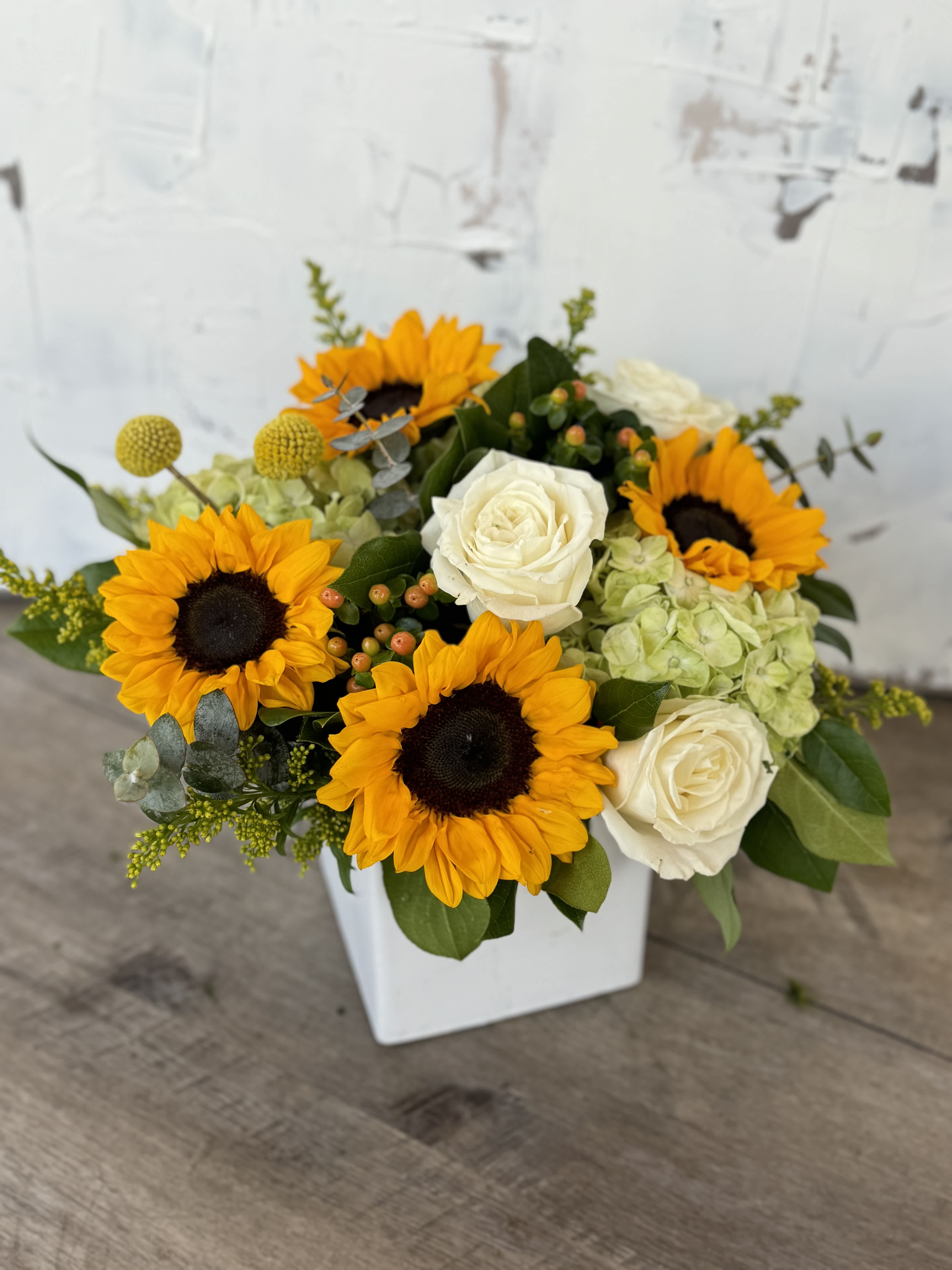 Golden Glow Golden Glow - Each arrangement is custom designed, using seasonal, best-of-day blooms. The image shown represents its size, style and temperament, however certain flowers may be substituted to achieve the best quality and longevity for your florals.