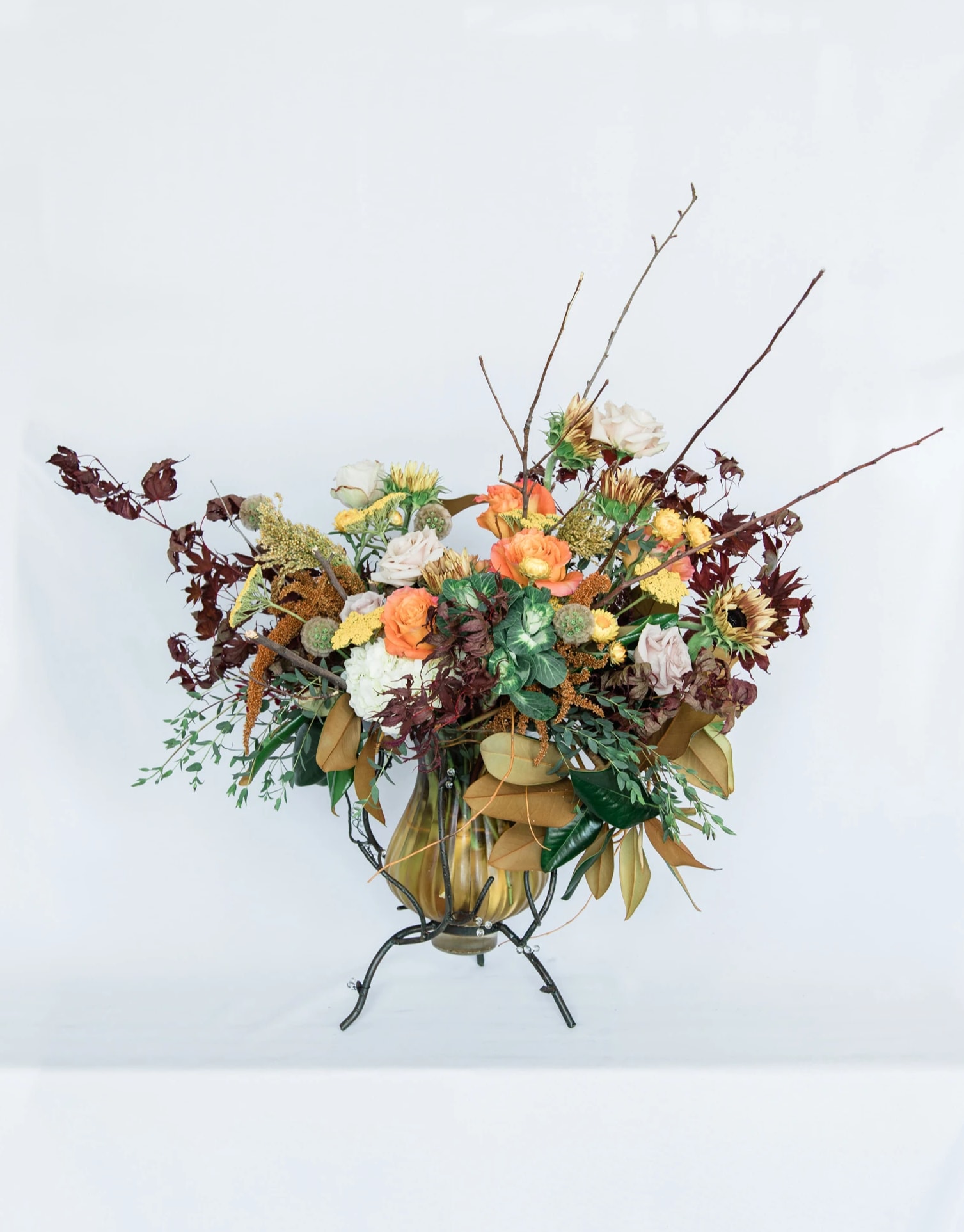 Fostering Thanks - Express your gratitude with our new Thanksgiving Collection! Inspired by the warmth of Thanksgiving, the Fostering Thanks comes arranged with a beautiful mix of autumnal premium blooms and textures, all eloquently designed in one of our hand-picked designer vases.  Pictured [DELUXE]  *Some items in this arrangement must be special ordered, please allow 1-2 weeks notice to allow time for arrival of special items, otherwise, substitutions will occur.*