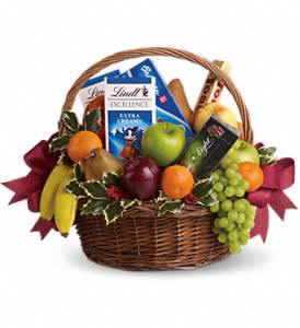 Fruits and Sweets Christmas Basket Fruits and Sweets Christmas Basket - Even if your gift list seems like it's endless this year, sending anyone a sweet holiday gift is beautifully easy. This basket is fresh, festive and fabulous. Oh, and did we mention delicious?  Fresh green, red and yellow apples, bananas, grapes, pears and tangerines are arranged with an assortment of gourmet chocolate bars and cookies. Add Christmas holly and red ribbons and you've got one heck of a healthy Christmas gift.  Approximately 19" W x 16" H   Please note: All of our bouquets and gift baskets are hand-arranged and delivered locally by professional florists. This item requires additional lead time of at least one day, so same-day delivery is not available.  Orientation: N/A  As Shown : T135-2A Deluxe : T135-2B Premium : T135-2C