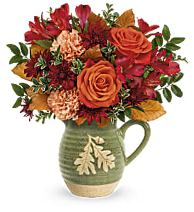 Teleflora's Charming Acorn Bouquet Teleflora's Charming Acorn Bouquet - Teleflora's Charming Acorn Bouquet embraces autumn. This charming glazed stoneware pitcher is bursting with fall flowers like roses, carnations, alstroemeria, and chrysanthemums! The embossed design vase is food- safe for years of pouring pleasure. Approx. 13 3/4 W x 14 1/4 H