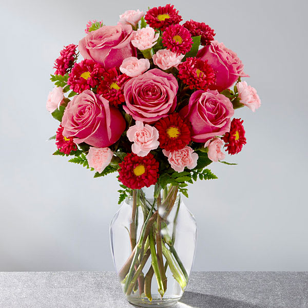 The FTD Precious Heart Bouquet The FTD Precious Heart Bouquet - The FTD® Precious Heart™ Bouquet is an expression of love and sweet surprises that is set to truly delight your special recipient! Popping with the swirl of hot pink roses surrounded by the alluring textures of red matsumoto asters and pale pink mini carnations all beautifully accented with lush greens this fresh flower arrangement has a winning look everyone can appreciate. Presented in a clear glass vase this gorgeous flower bouquet is ready to create an excellent birthday thank you or anniversary gift. GOOD bouquet is approx. 14"H x 12"W. BETTER bouquet is approx. 15"H x 13"W. BEST bouquet is approx. 16"H x 14"W.