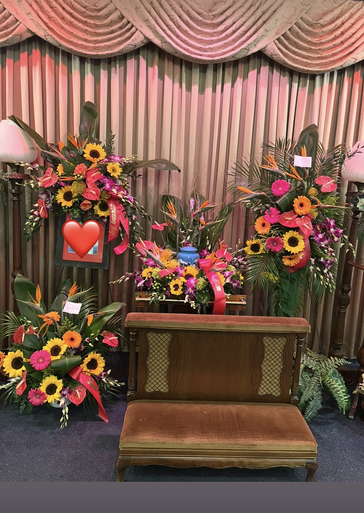 Tropical sympathy package  - Tropical flowers arranged in a wreath around the urn, a standing spray, a floor basket and a spray above your provided photo. Tropicals need to be ordered ahead of time so please call the shop for availability.