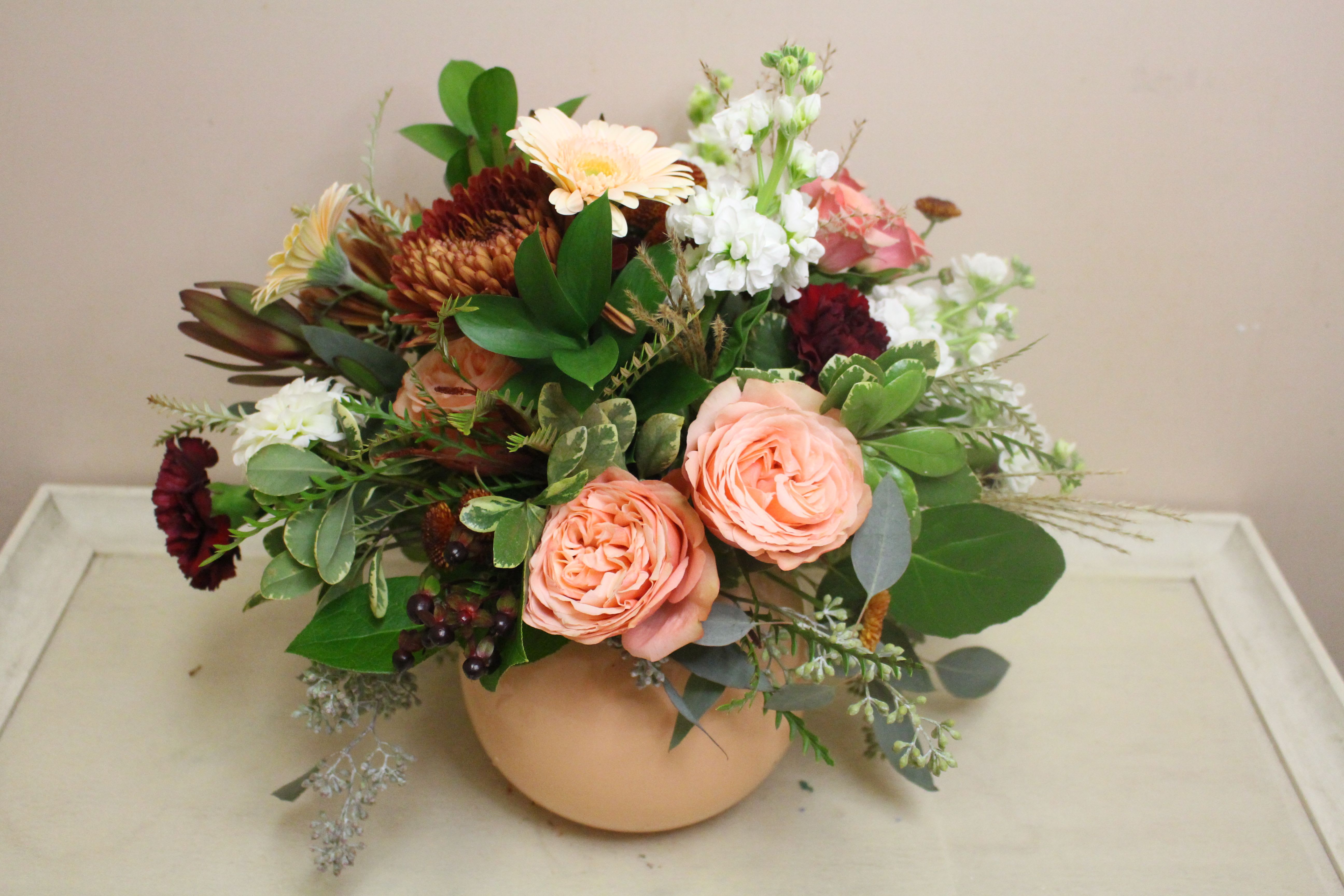 brisk autumn - peaches and sage, rust and cranberries all fill a peach vase.  A unique take on fall 