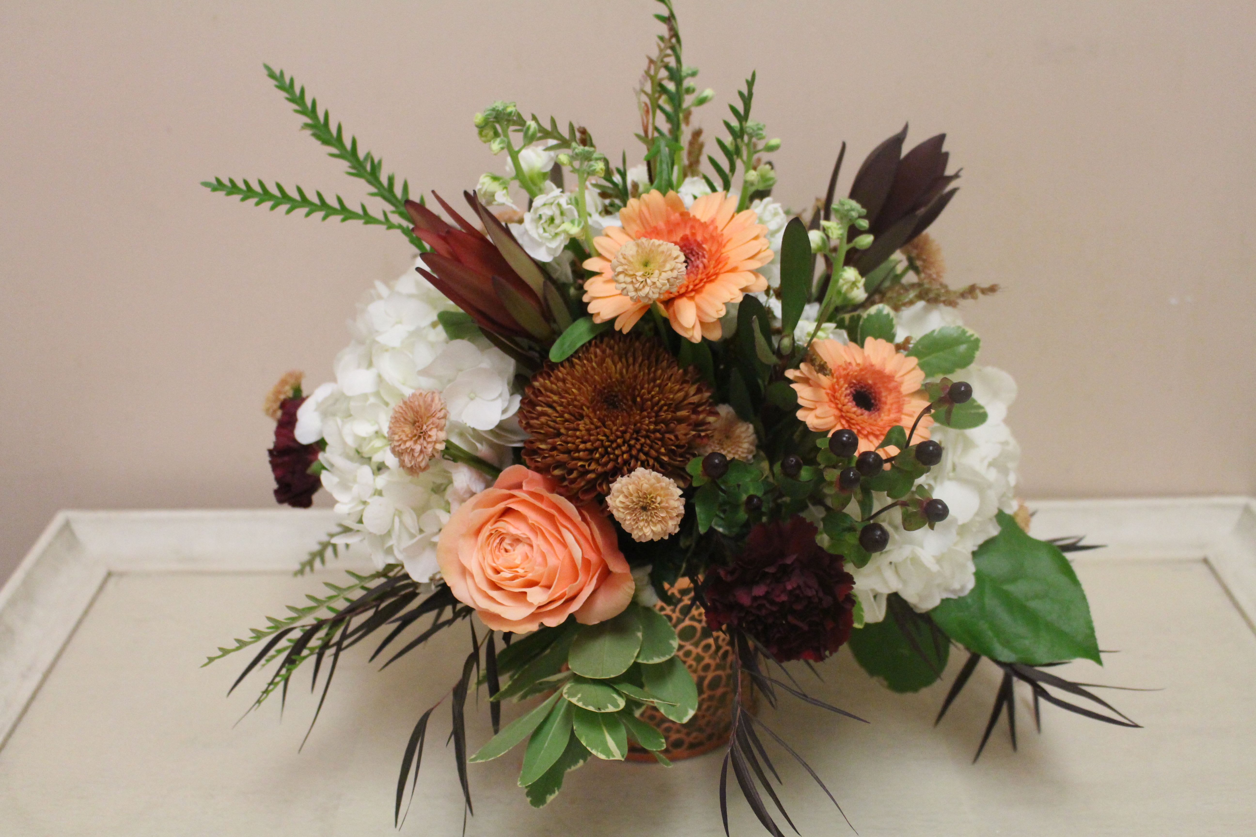 Fall blooms - in a copper vase sits shades of sage, peach. cranberry and copper