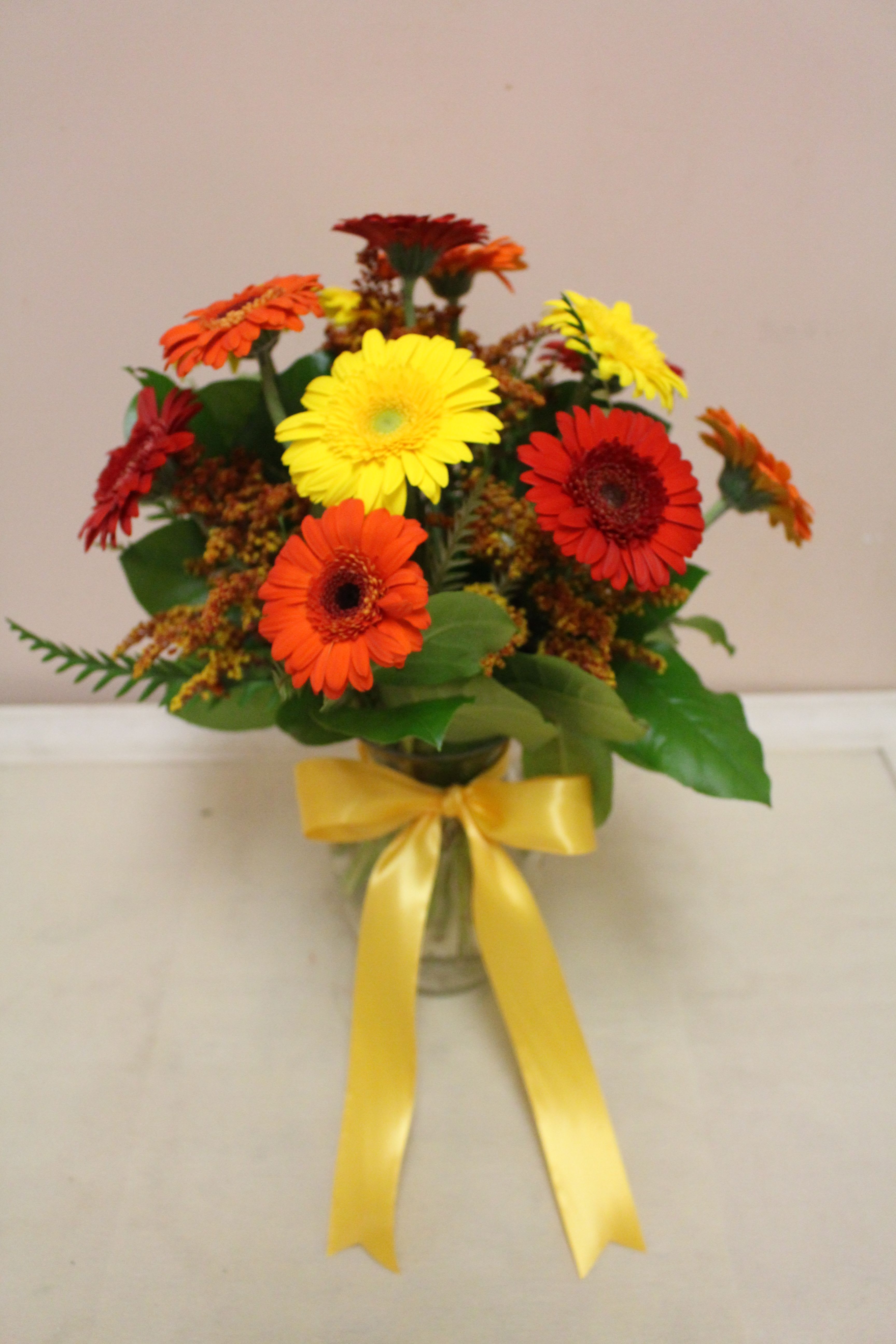gerbera dream bright -  A vase filled with gerbera daisies 