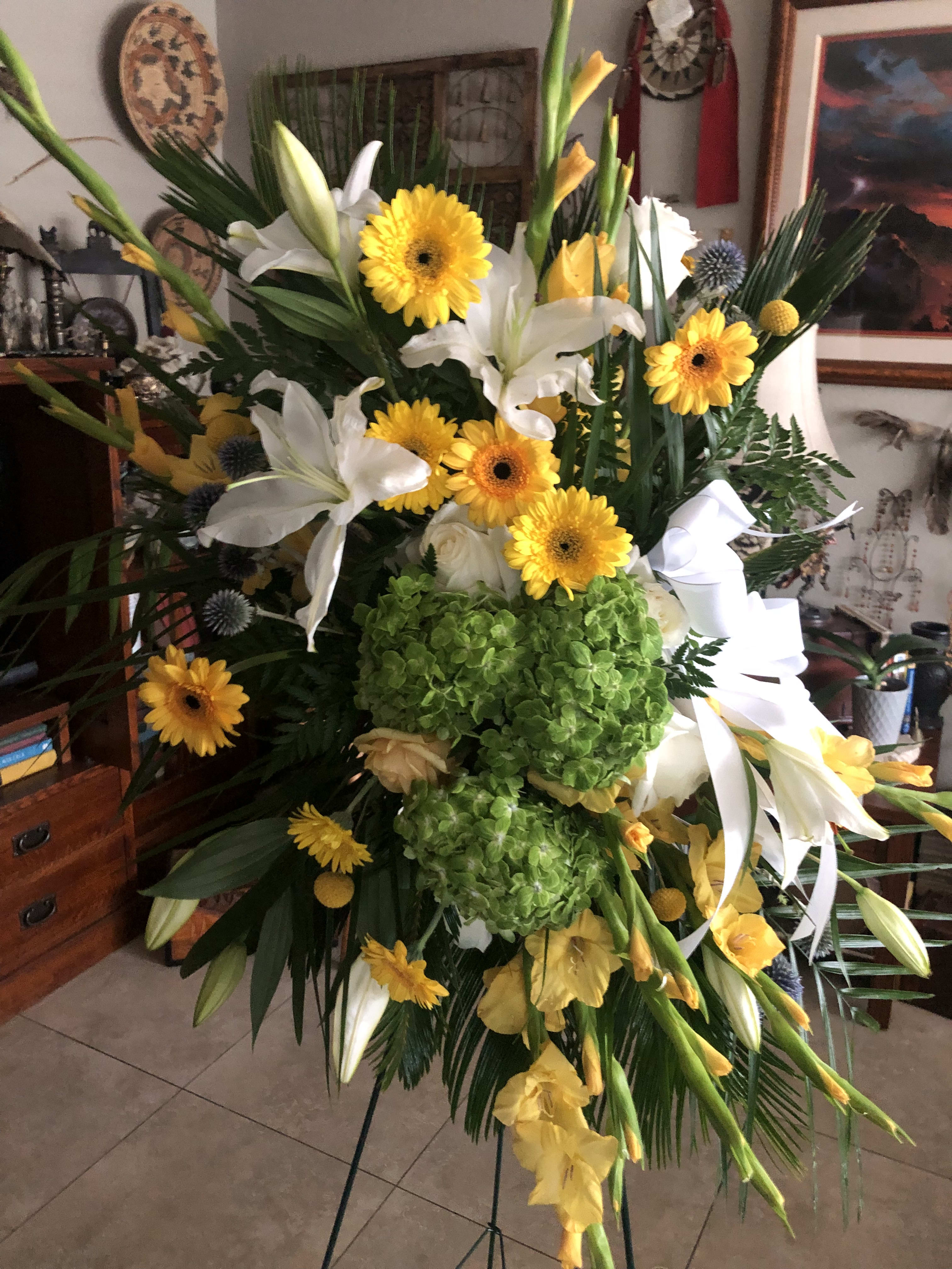 Yellow and White Standing Spray - A lovely standing spray of yellow and white seasonal blooms. Includes stand.