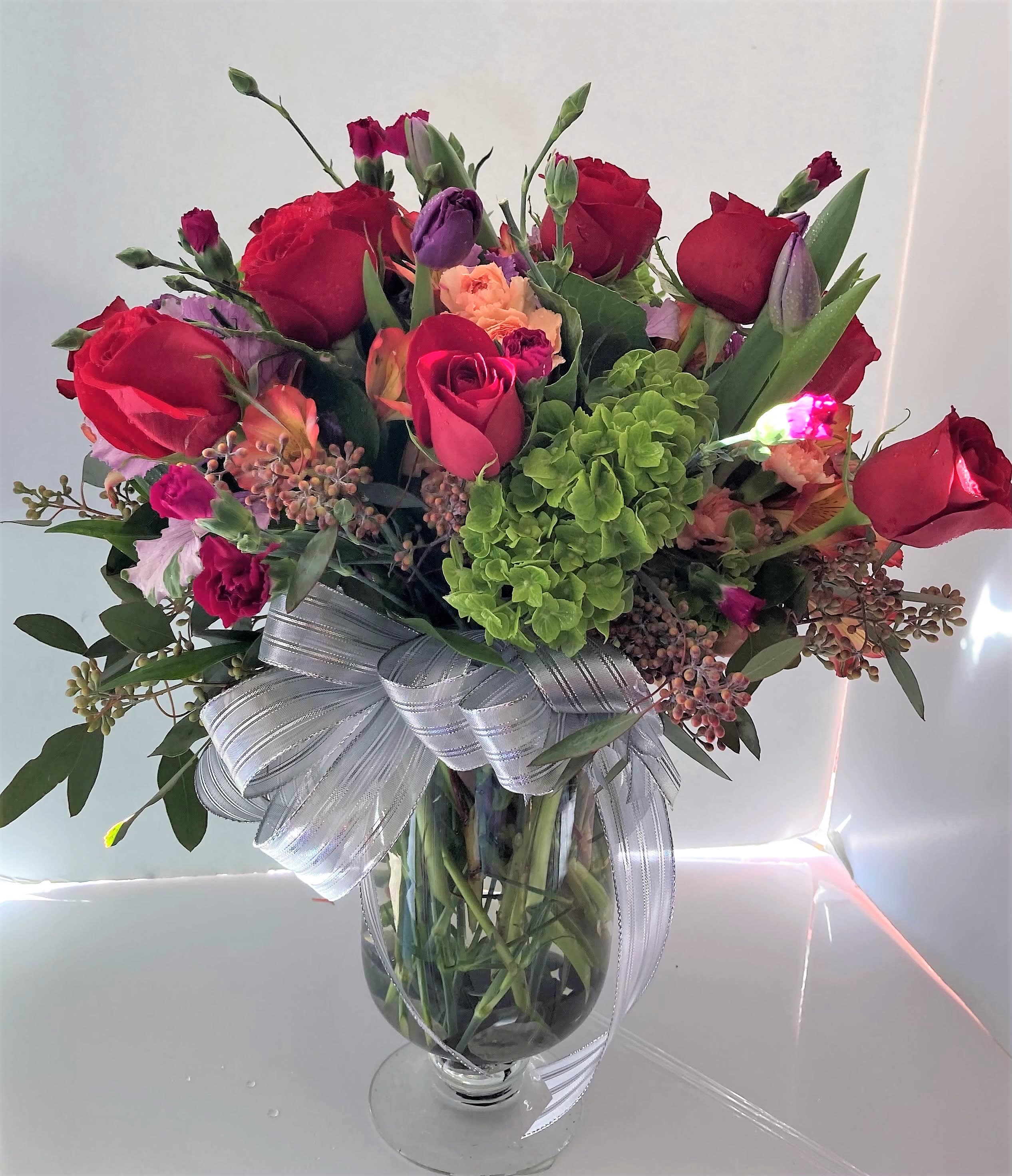 Bright Happiness - Assorted seasonal blooma in hot bright colors and a custom vase.