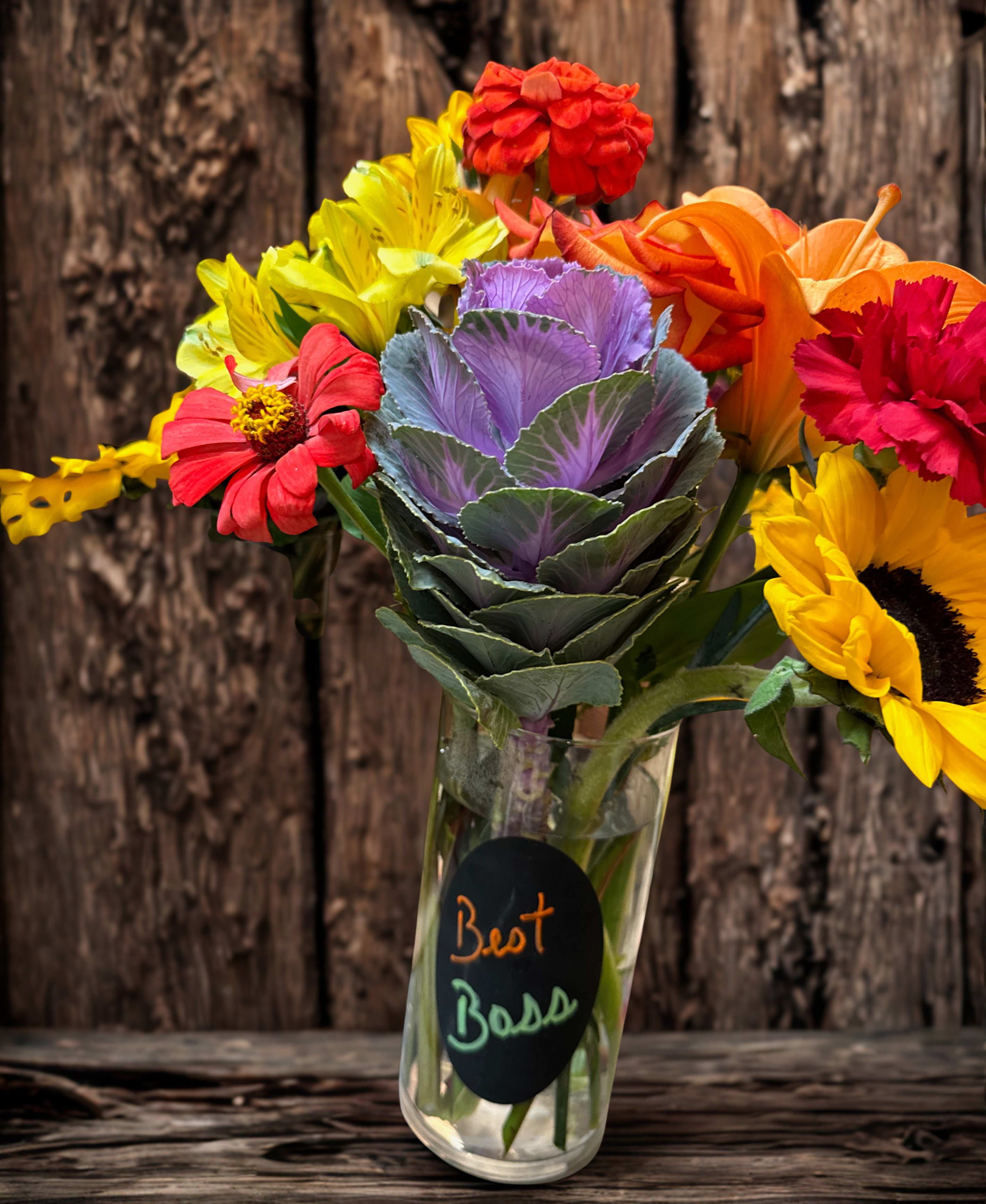 Best Boss Bouquet - Med to large vase arrangement filled with seasonal flowers. Including roses, carnations, ornamental kale, filler flower and greenery. Boss's Day is Oct. 16. Say thanks to the best boss ever. Vase may very. All flowers fresh and long lasting reflecting the fall season. 