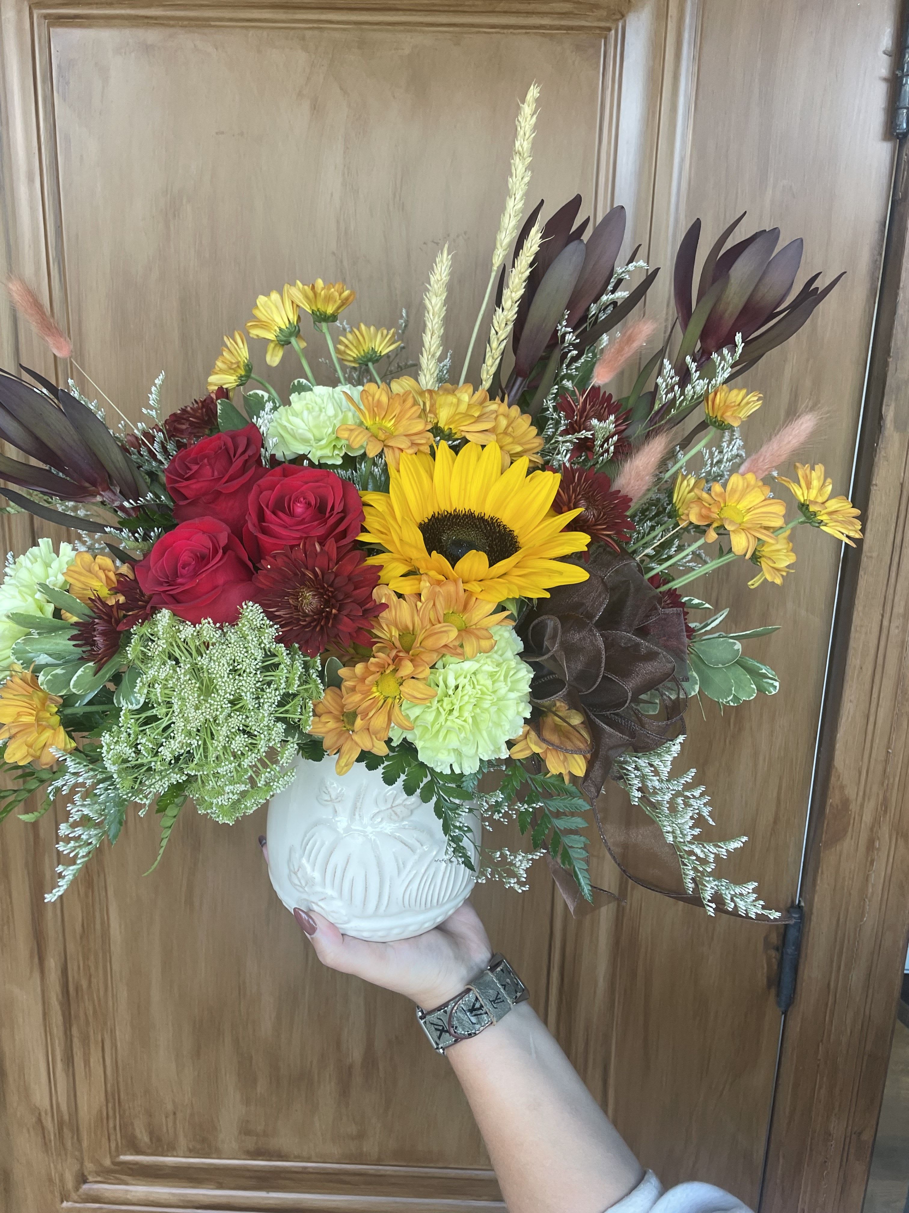 Hayride by Lotherington's - The ultimate flower mix featuring sunflowers and a variety of fall flowers in a beautiful pumpkin ceramic dish. Send this arrangement for Halloween, Thanksgiving, or to celebrate someone's birthday. 