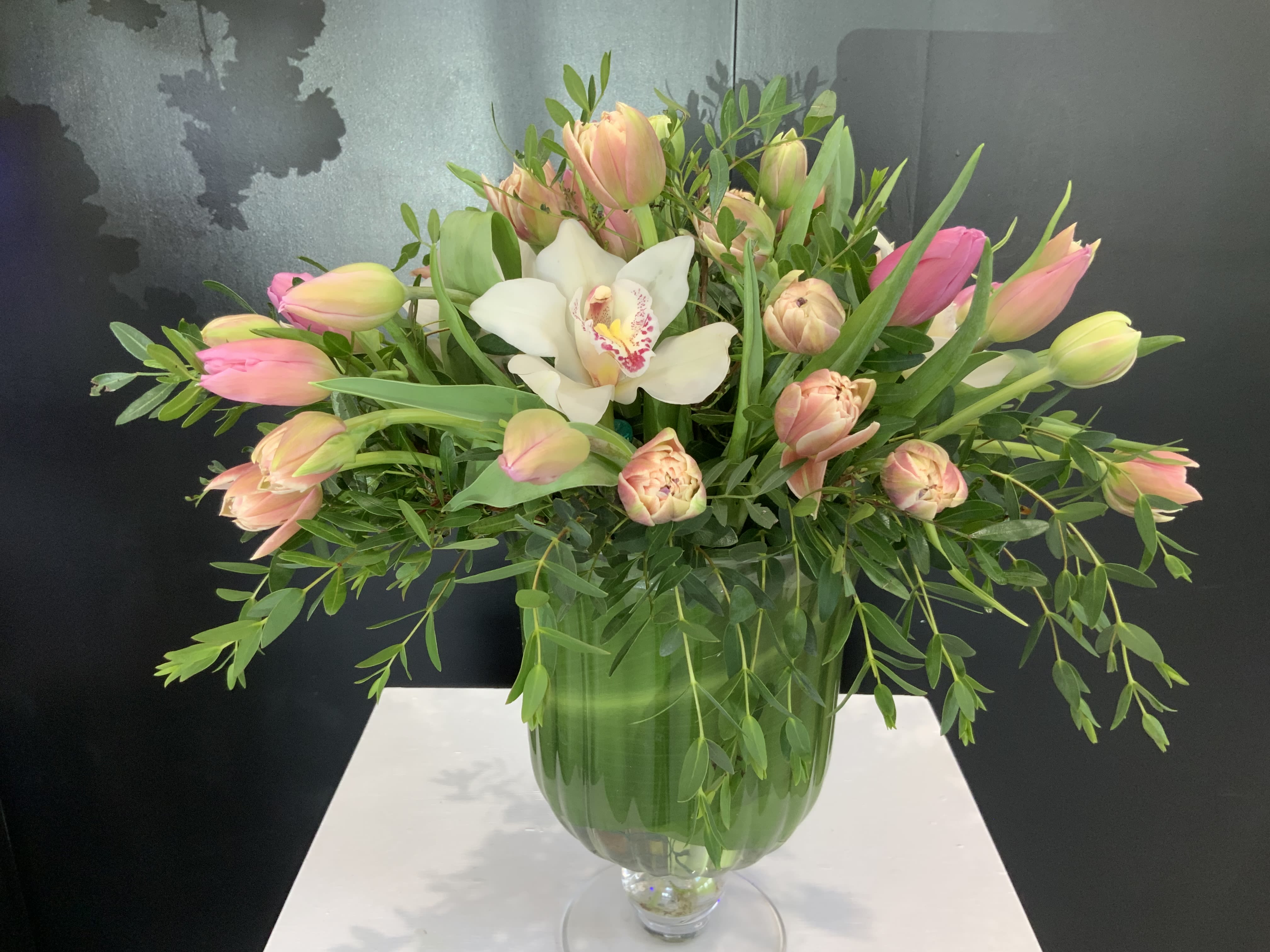 Tulip Elegance  - Celebrate the simple beauty of tulips with our sophisticated Tulip Elegance Bouquet. Featuring an elegant assortment of tulips in various shades, this monochromatic arrangement exudes timeless style and grace. Perfectly presented in a chic glass vase, the Tulip Elegance Bouquet is a versatile and refined choice for any occasion, from birthdays to housewarmings.