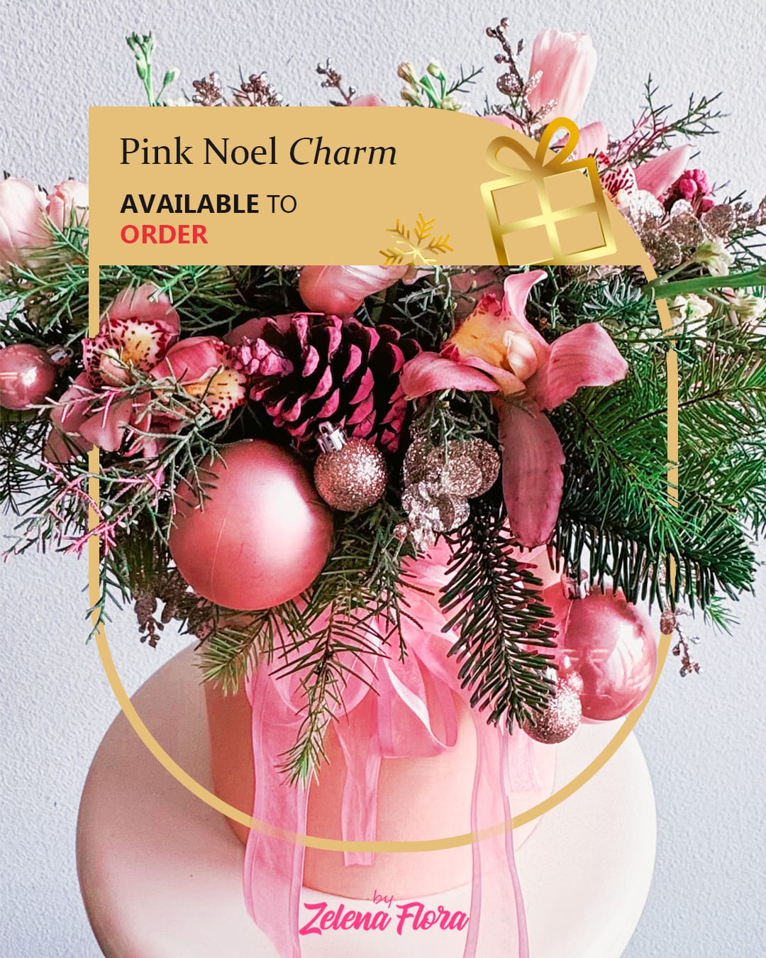 Pink Noel Charm Pink Noel Charm - This Christmas arrangement is a festive and elegant centerpiece designed to bring warmth and sparkle to the holiday season. It features a harmonious blend of natural greenery, delicate pink orchids, soft tulips, and shimmering decorative elements. The bouquet is crafted in a pink hatbox, tied with a flowing sheer ribbon, adding a modern yet enchanting touch.  Description of Elements: Natural components: Fresh fir branches, pink orchids, and tulips. Decorative items: Glittery pinecones, sparkling ornaments, small baubles, and metallic accents. Container and wrapping: Pink hatbox and a sheer pink ribbon.