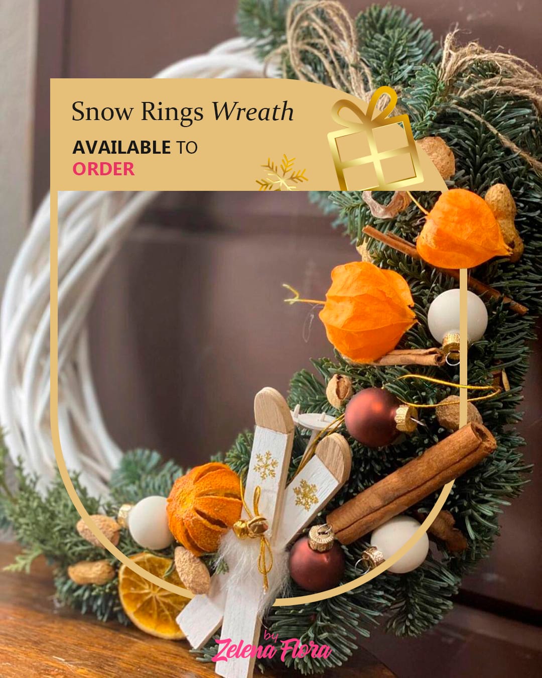 Snow Rings Wreath Snow Rings Wreath - This delightful Christmas wreath exudes warmth and festive cheer, crafted with love and attention to detail. The wreath features lush evergreen branches, bright orange physalis, dried orange slices, cinnamon sticks, almonds, and elegant ornaments in white and bronze. Adorned with rustic jute twine and charming wooden skis with gold snowflake details, it embodies the magic of a cozy winter holiday. This wreath belongs to the rustic farmhouse style, blending natural materials with a touch of vintage charm, perfect for creating a welcoming and homely Christmas atmosphere.