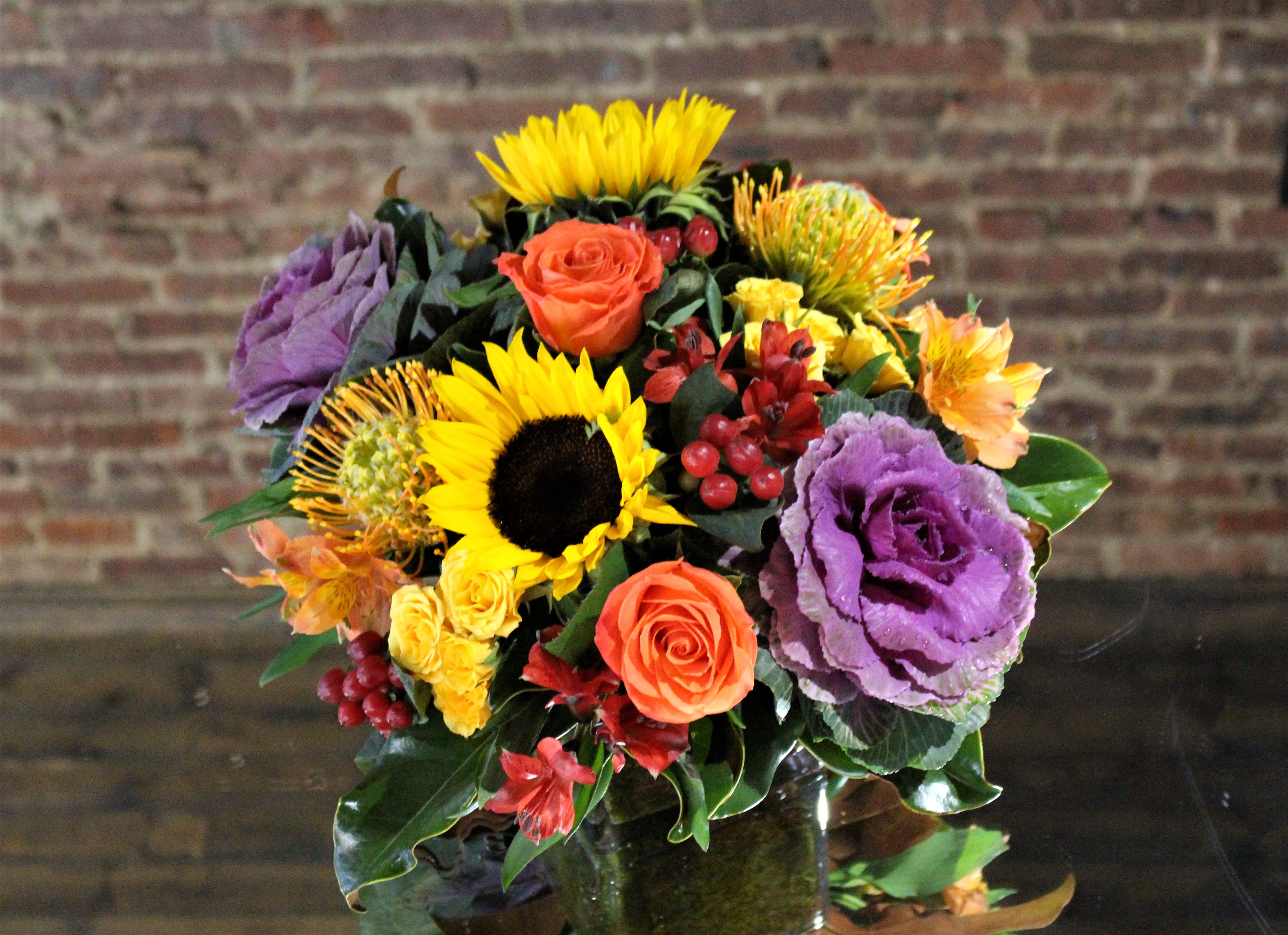 Shades of Autumn - Autumn is all about color. Designed with the vibrant shades of the season, this bouquet comes with an assortment of texture and color.  Orientation: All-Around All prices in USD ($) Standard (Shown), Deluxe , Premium