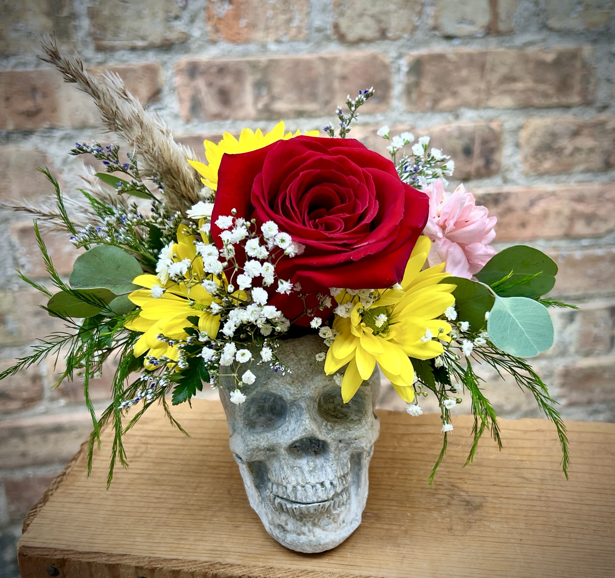 Calaveras Calaveras - This adorable little skull is filled with beautiful mixed flowers. The skull is made from cement and can be used again and again. A really fun gift for anyone who likes to see the world from a different angle. Approximately 7" H x 7" W. We are proud to deliver our flower creations to the Kenosha, Somers, and Pleasant Prairie area. With over 55 years of combined flower design experience in Kenosha, Wisconsin, A Summer's Garden Florist and Gifts is the perfect choice for the freshest flowers, the most creative design, and exceptional customer service.