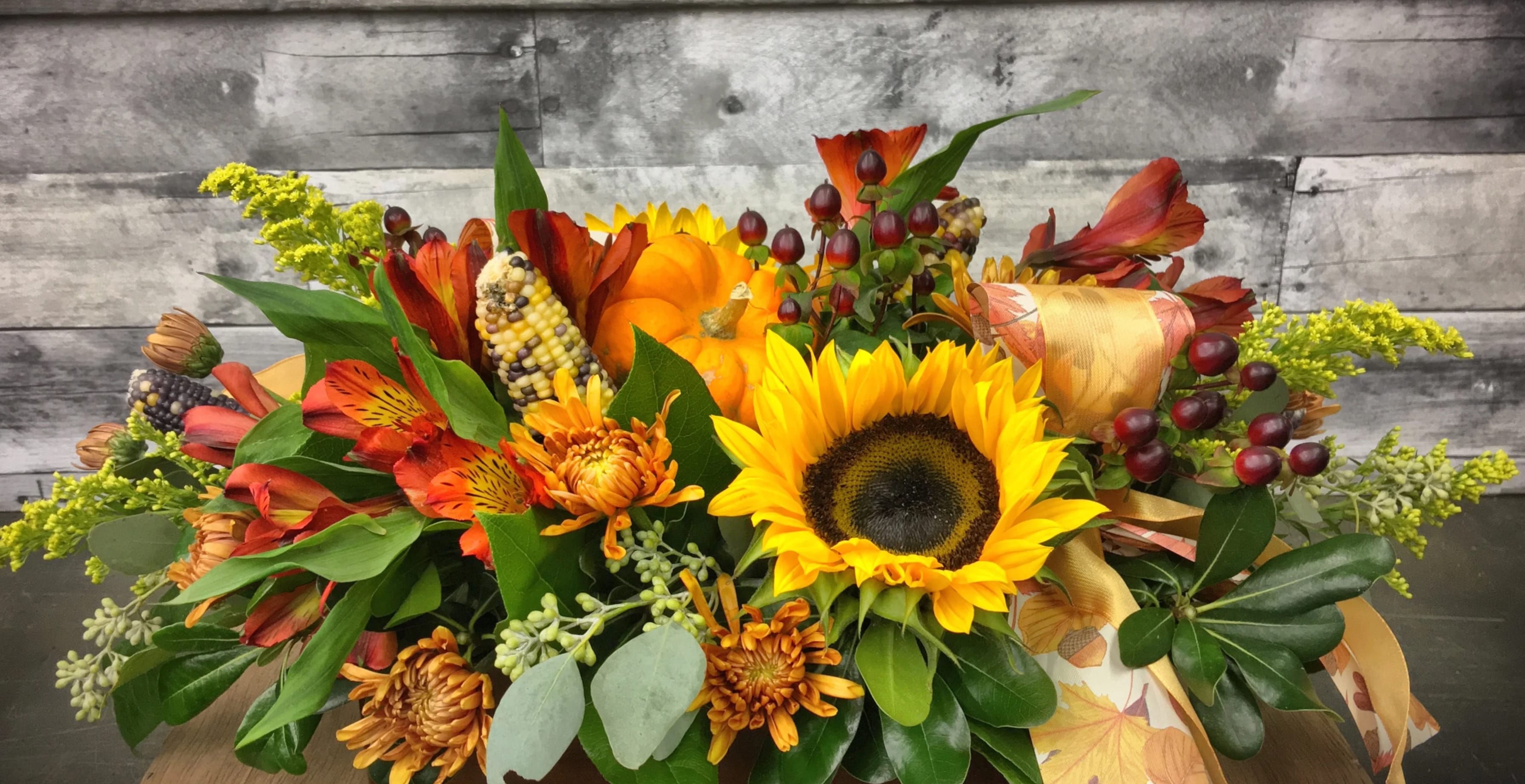 Harvest Harvest - A lovely collection of fall flowers with touches of indian corn, mini pumpkins and eucalyptus. Perfect for your harvest table.